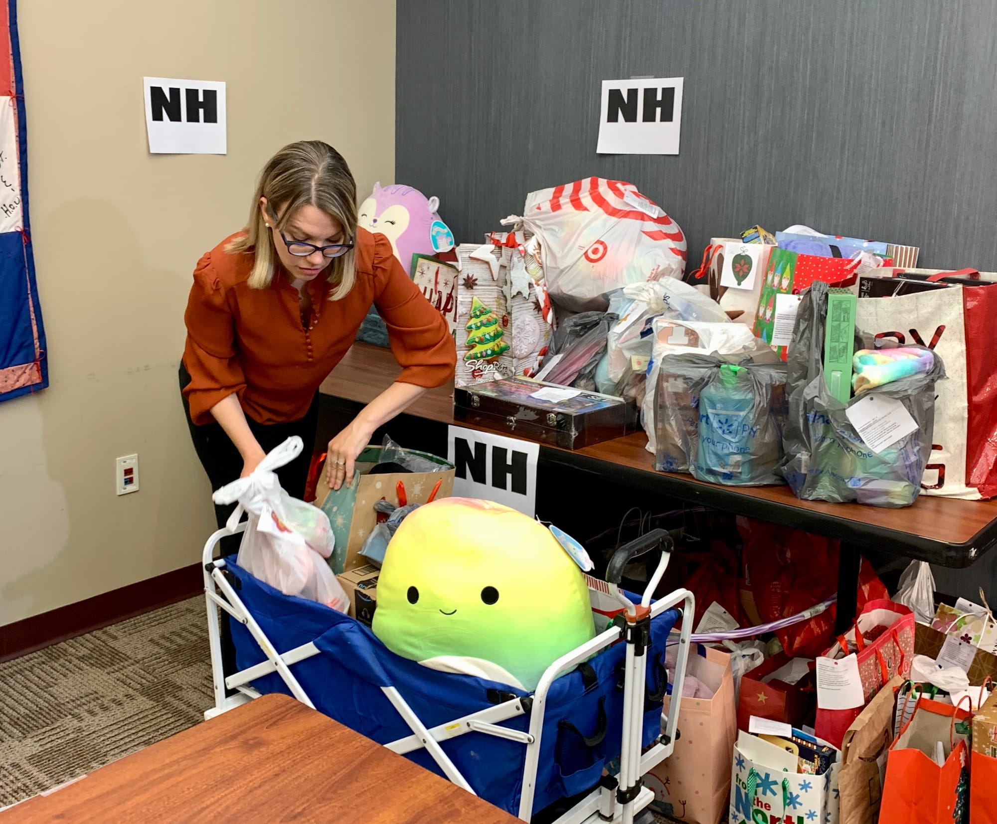 KidsPeace Director of Development Missy Hartney packs up gifts to send to KidsPeace residential facilities.