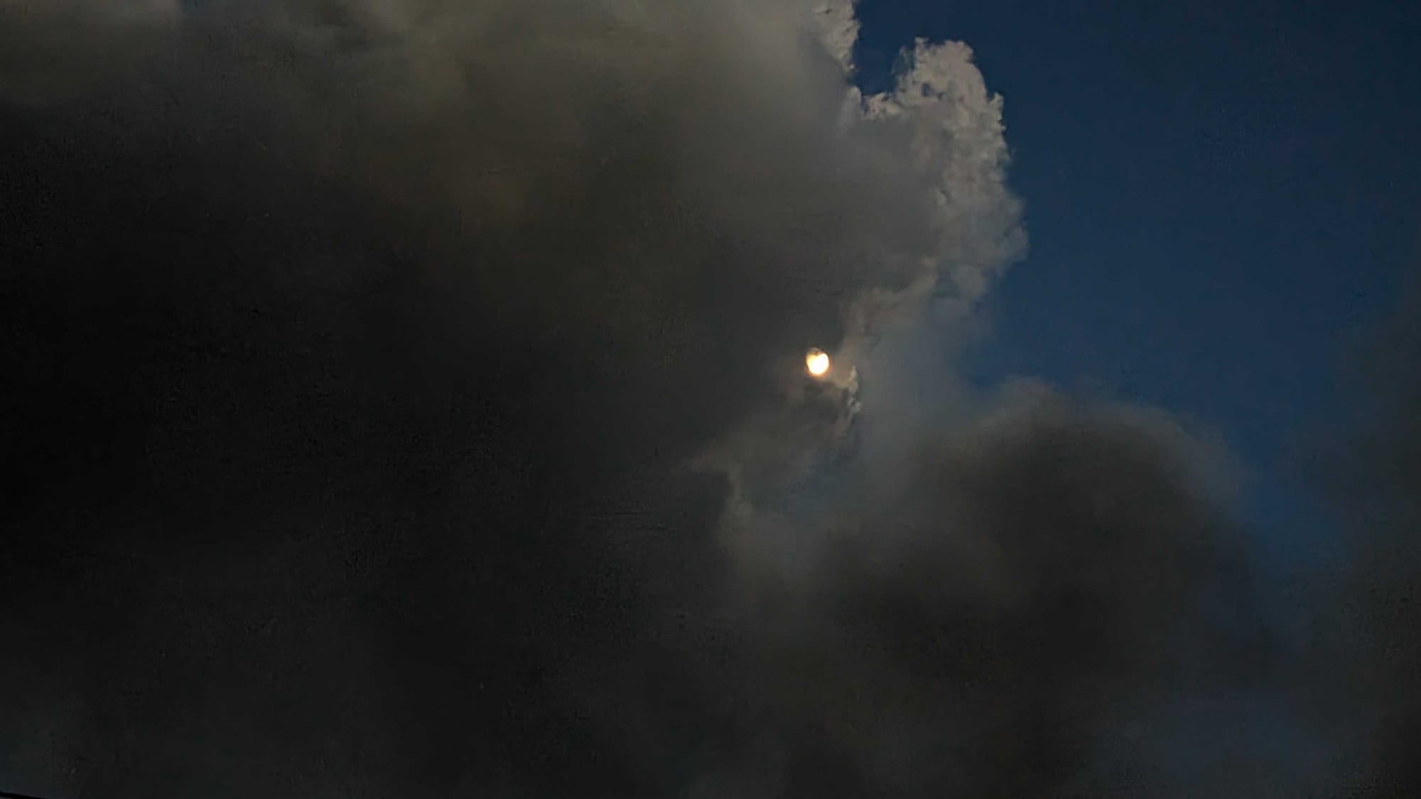 Smoke shrouds the moon Wednesday night as smoke from a massive fire drifts over the sky in Allentown.