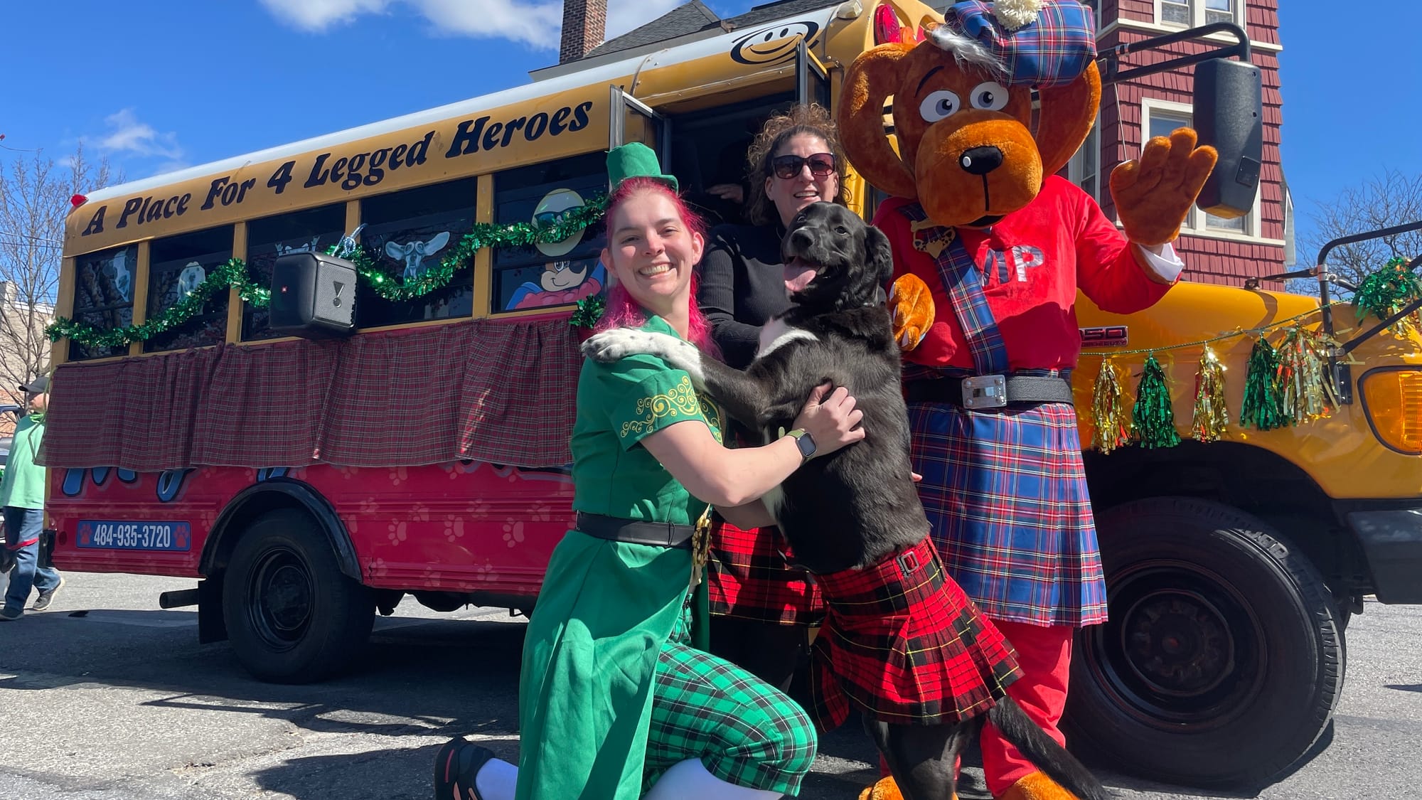 Turnip the Pyrenees Cattle Dog dons a red kilt and smiles alongside friends from MIGHTYPAWZ of Bethlehem on Saturday, March 1