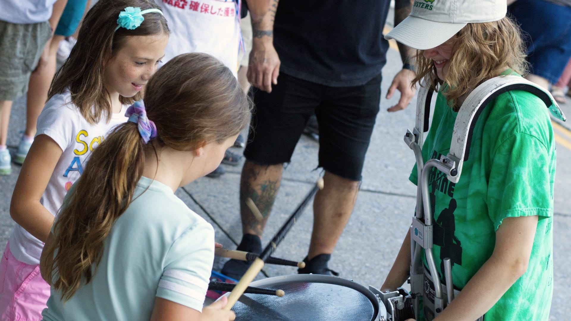 Camryn Cobos, a founding member of Orbital Drum Line, encourages young girls to drum.