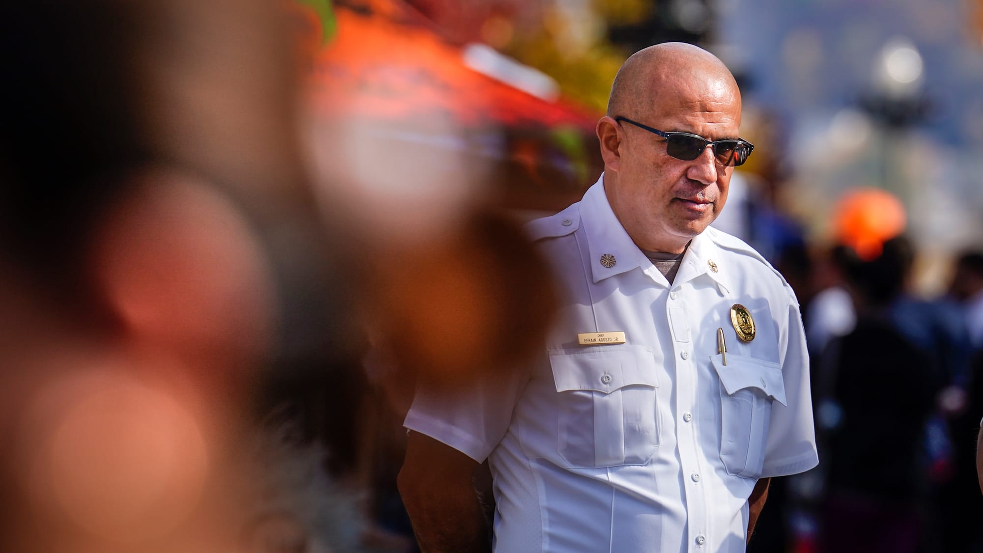 Allentown Fire Chief Efrain Agosto, Jr. watches trick-or-treaters on Hamilton Street. Thousands turn out for the Allentown Ha