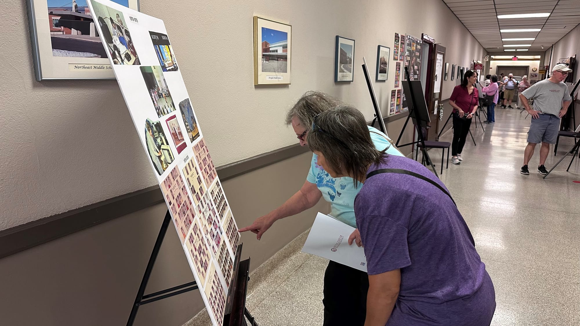 Visitors search for themselves and friends in old school photos.