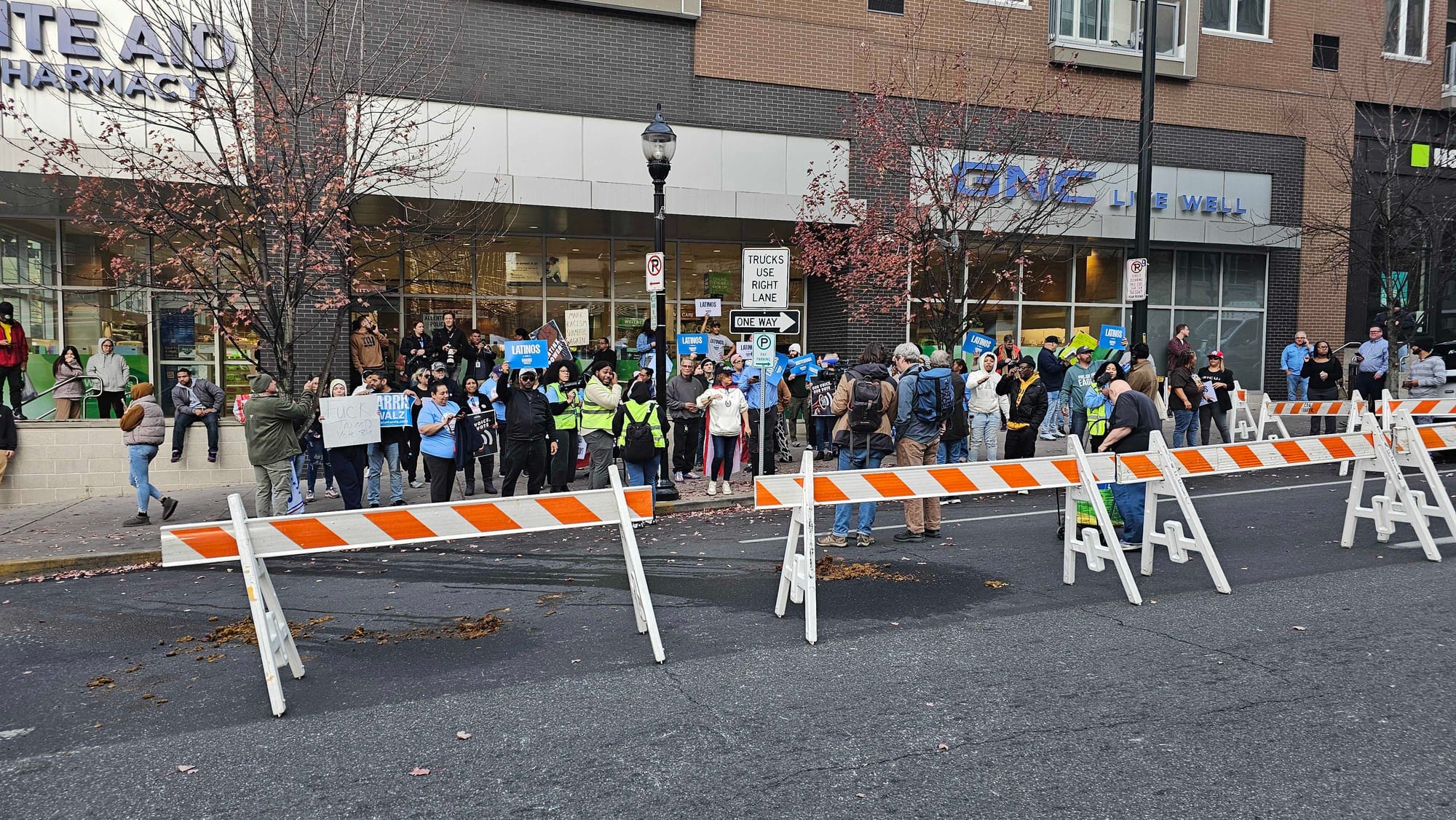 Protesters line up behind barricades ahead of a rally for former President Donald Trump at the PPL Center in Allentown.