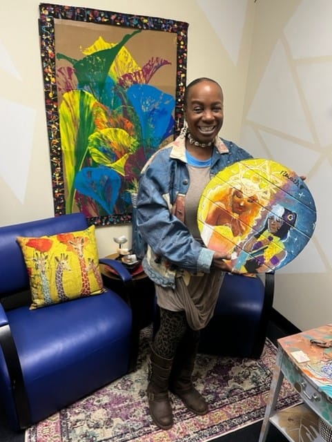 Robbie Matthews, the Director Sixth Street Shelter in Allentown, shows off the art she encouraged a teen girl living in the s