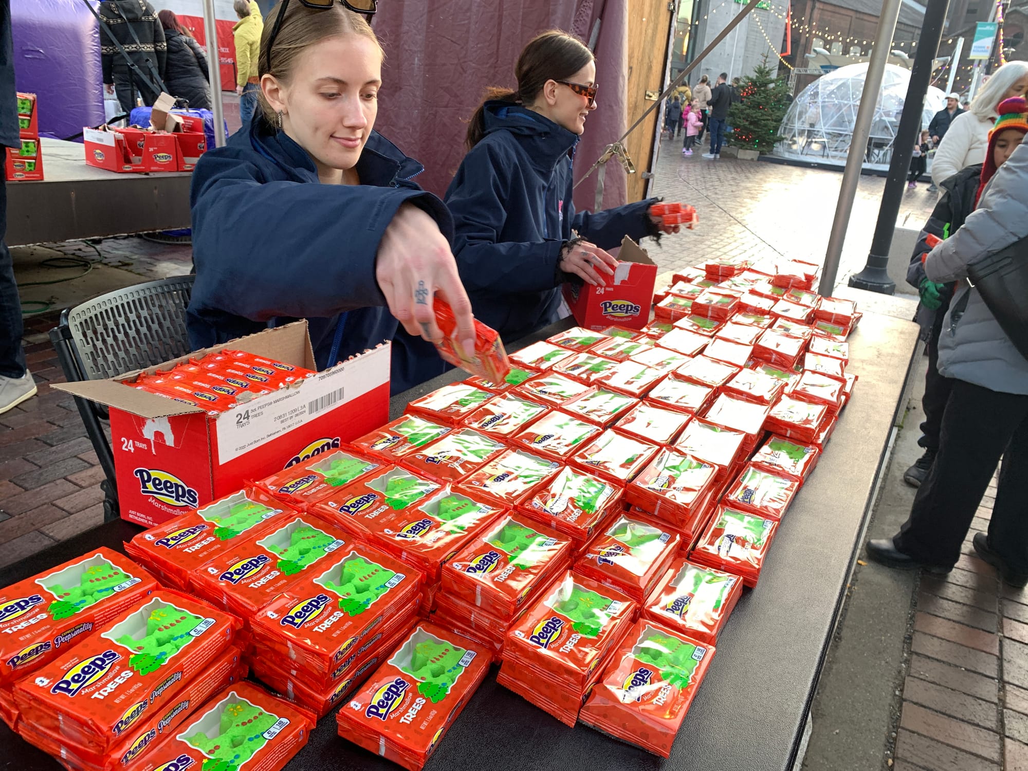 Peeps employees give out free packs of Christmas peeps.