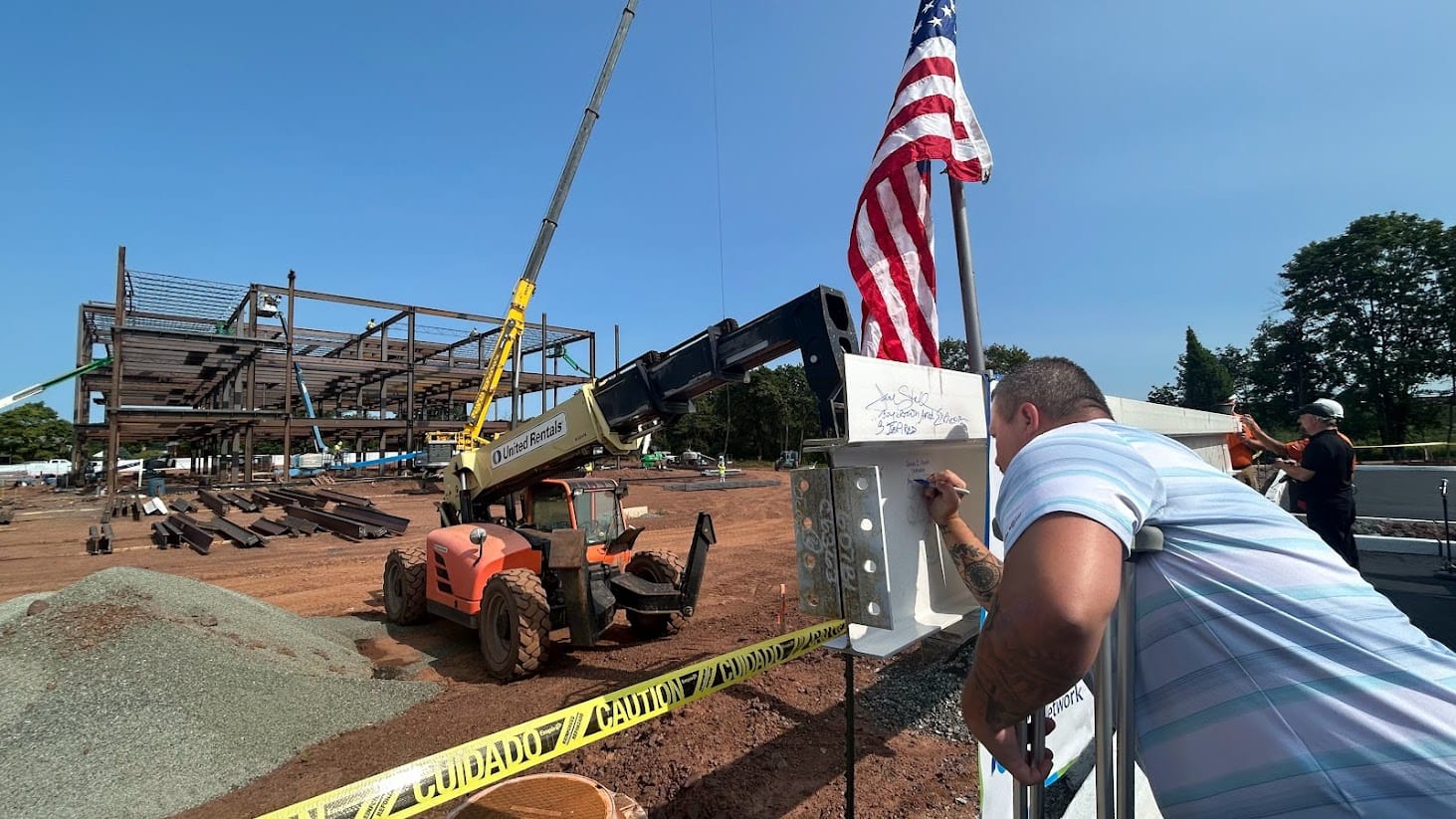 Joshua Stouch, chairman of the Board of Supervisors for Douglas Township signs the last beam to be placed on Lehigh Valley He