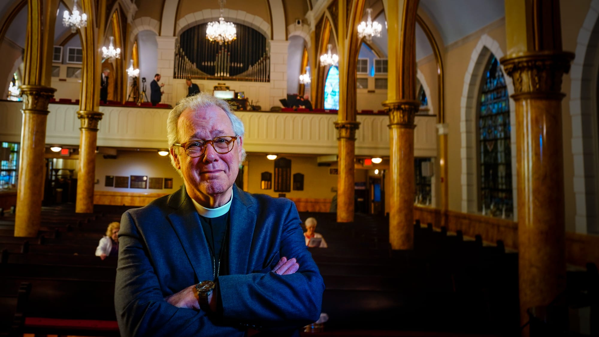 Rev. Mike Button, Interim Pastor, poses one last time at his altar. A Thanksgiving and Leave-Taking service was held at St. J