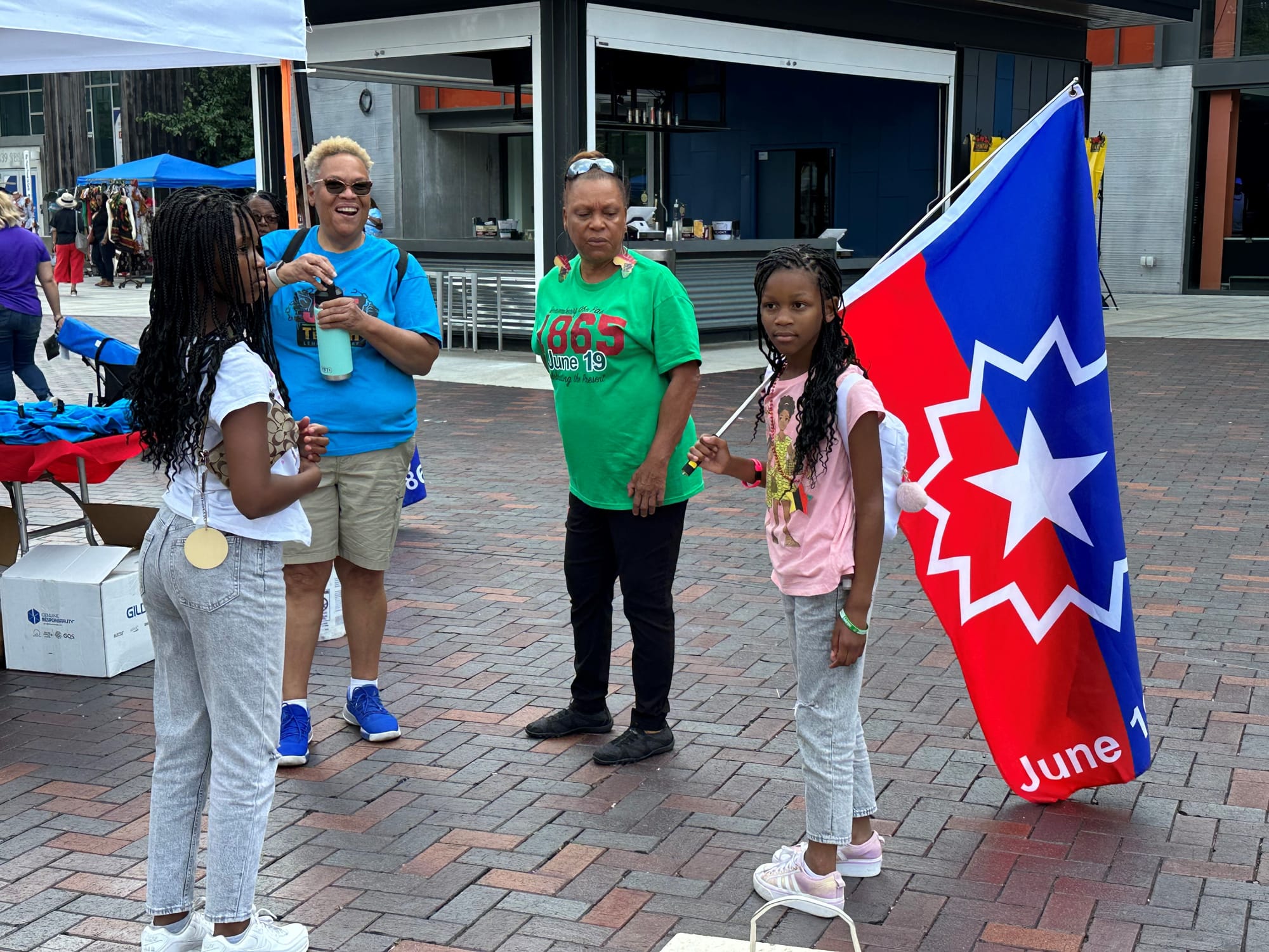 A young woman holds a Juneteenth flag at Juneteenth Lehigh Valley's celebration of the holiday at the Steel Stacks Saturday.
