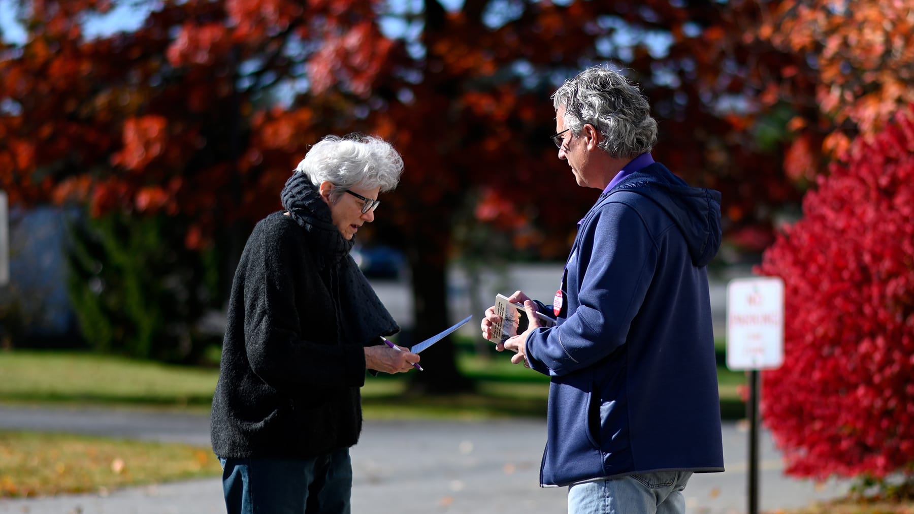 Robert Hodges, 60 (right), speaks to a voter outside the Calvary Temple polling place on Tuesday, Nov. 4, 2025 in South White