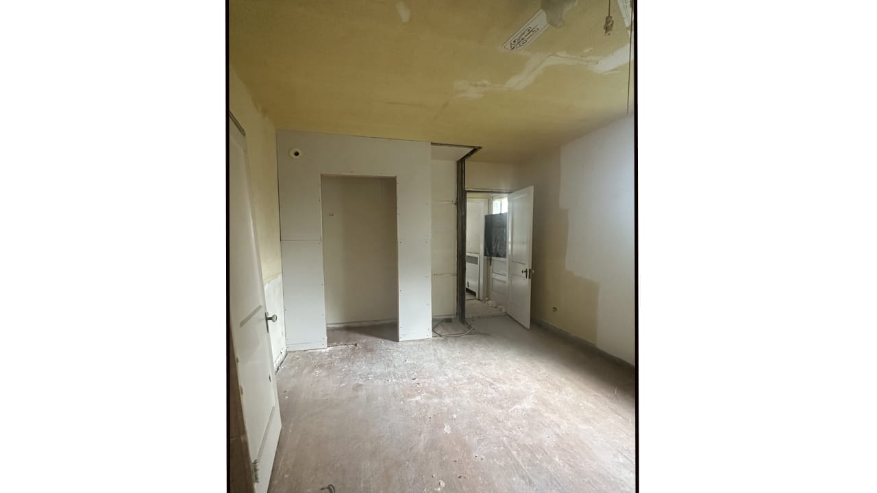 The home office before the renovation. Wallpaper was scraped off the walls and the ceiling.