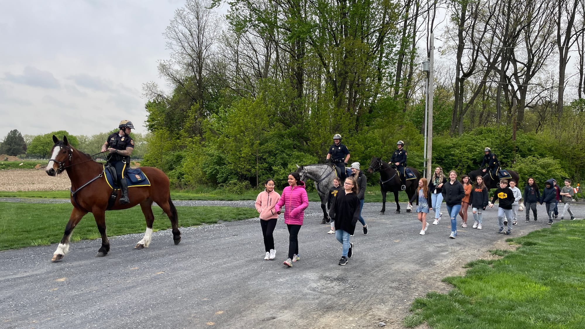 Spring Garden students approach the mounted police training facility, eager to plant their tree.