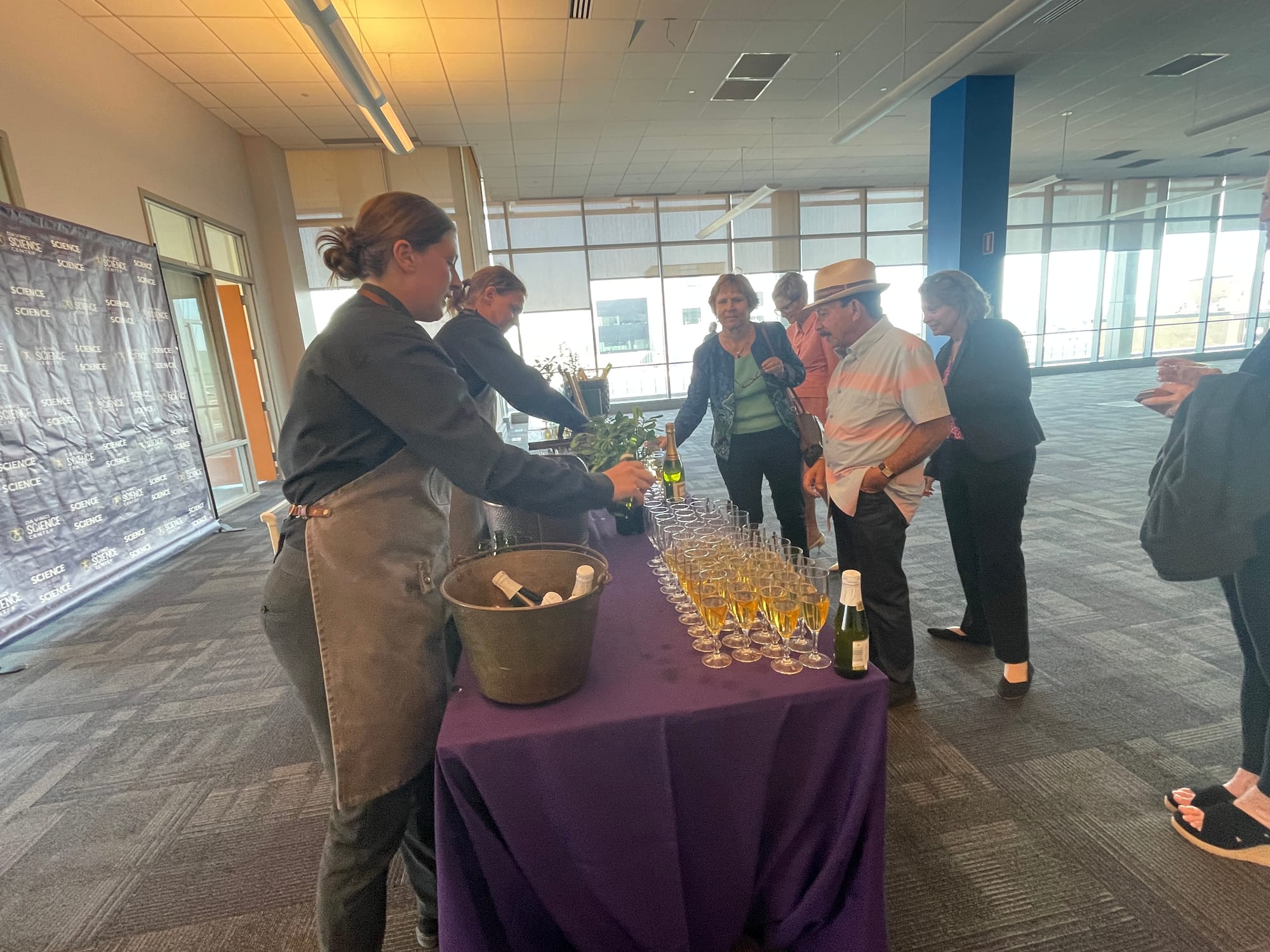 Beth van Horn, owner of HausBar, serves some champagne and apple cider for the guests to view the event from the seventh floo