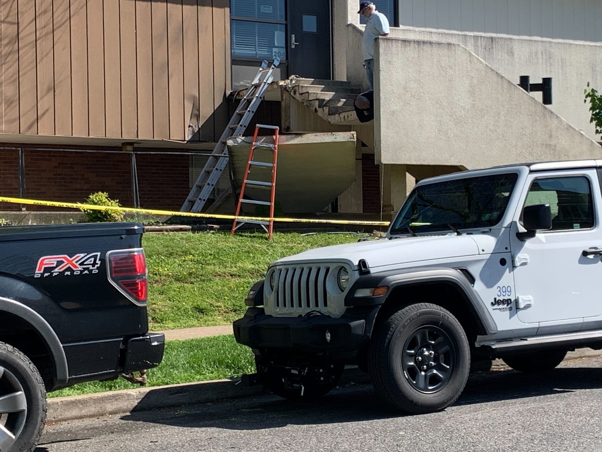 A man examining the exterior wall that collapsed on a stairwell at William Penn Elementary School in Bethlehem.