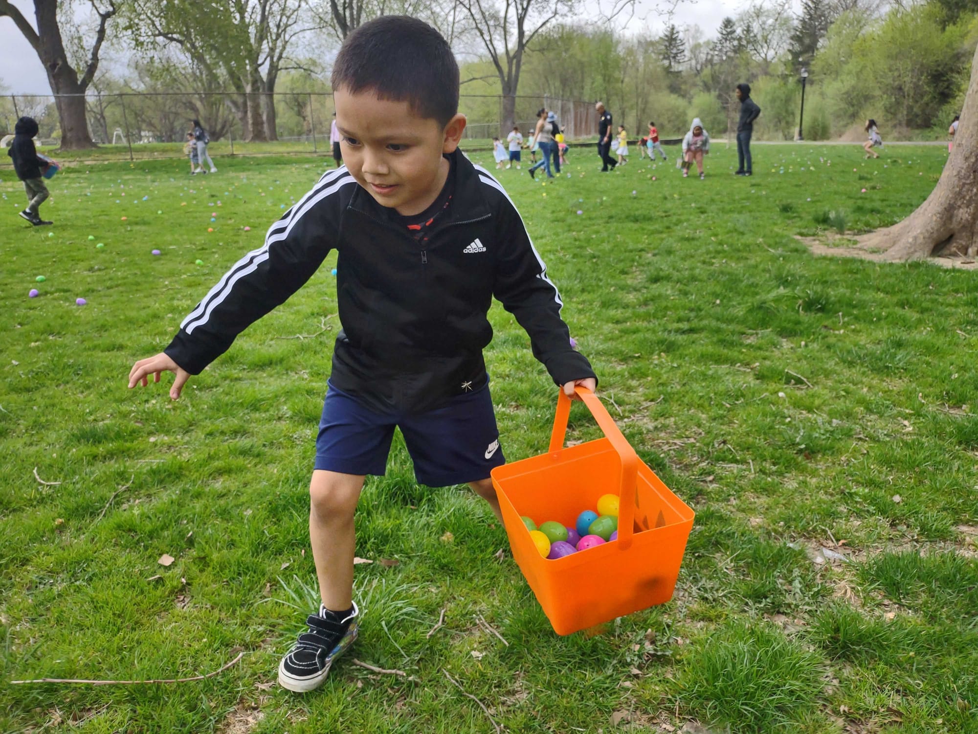 Joshua Garcia, 6, dashes around Jordan Park collecting eggs during the Mayor's Egg Hunt on Saturday, April 15, 2023.