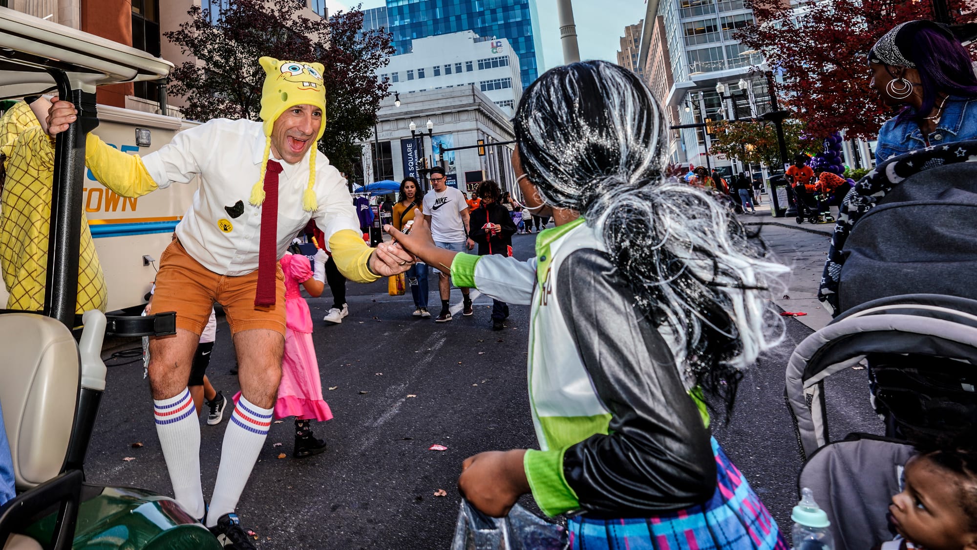 Mayor Matt Tuerk hands out candy along the route. Thousands turn out for the Allentown Halloween festivities. Allentown holds