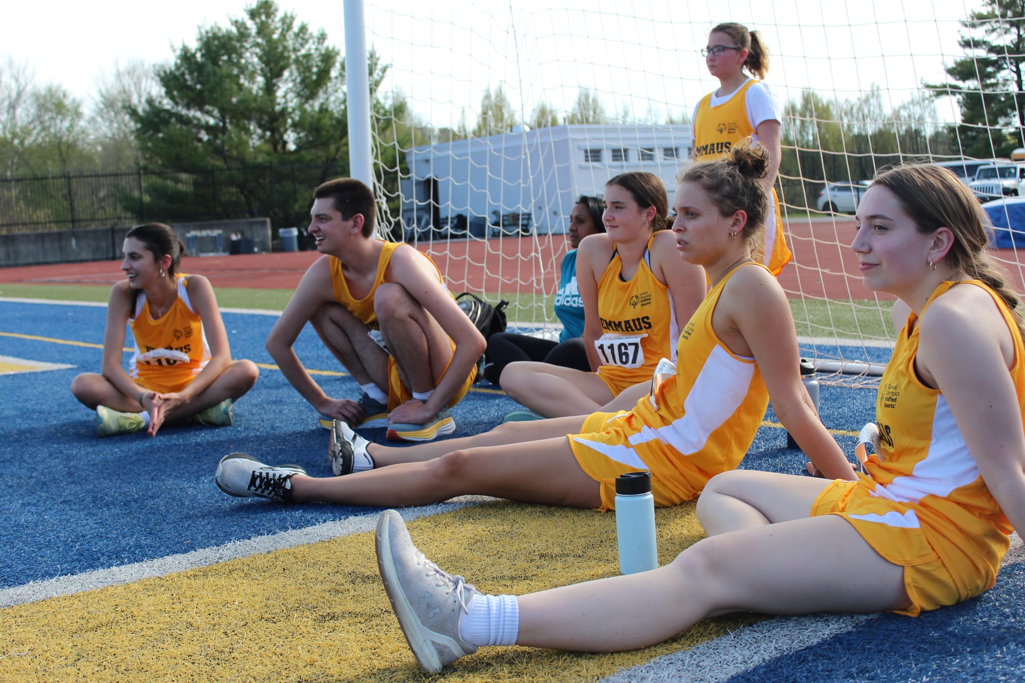 Students from Emmaus High School watching students from their team compete in the mini-javelin event