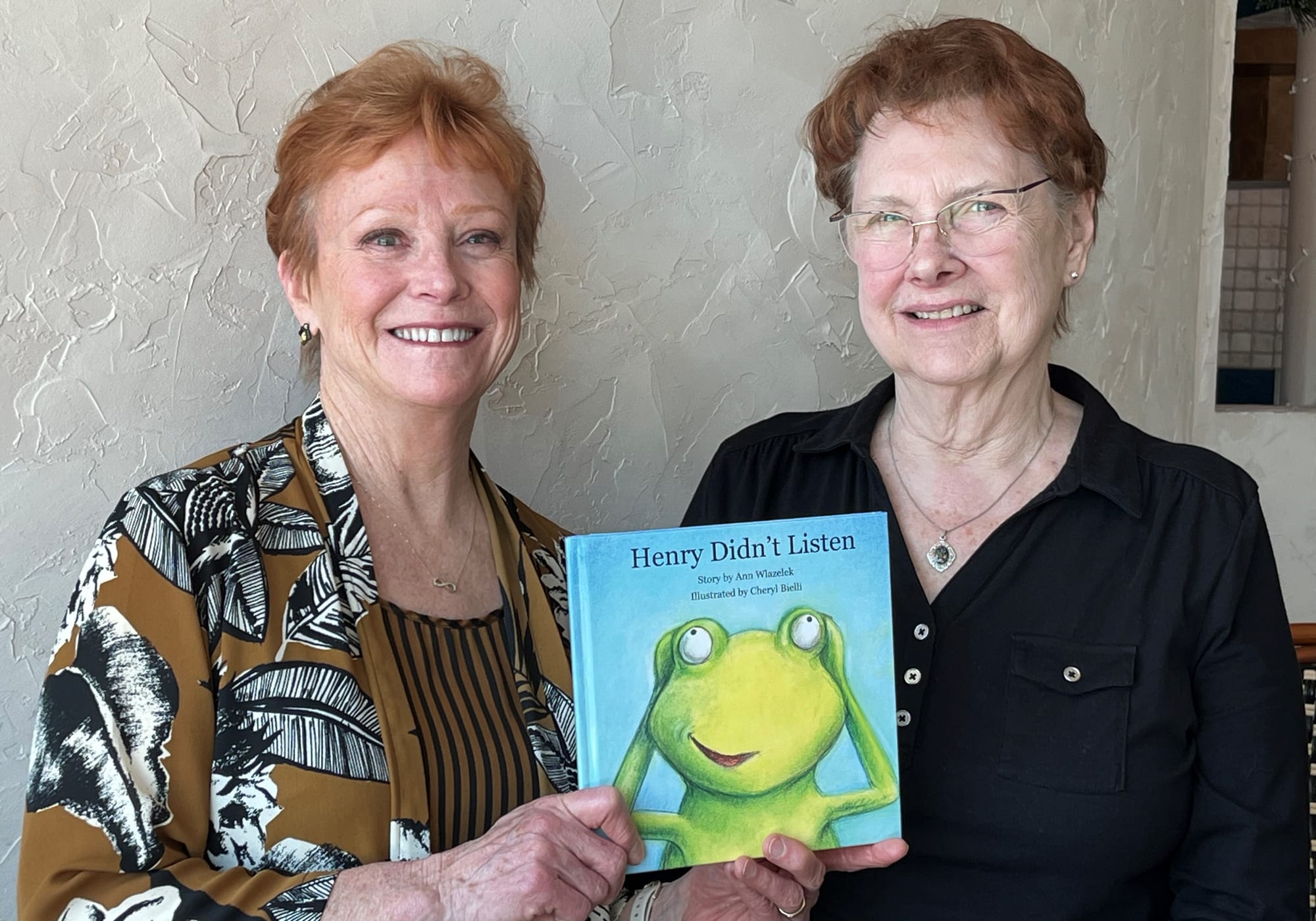 Ann Wlazelek (l) and Jane Budman with the book whose story was created by their mother, Gerda Fenstermaker.