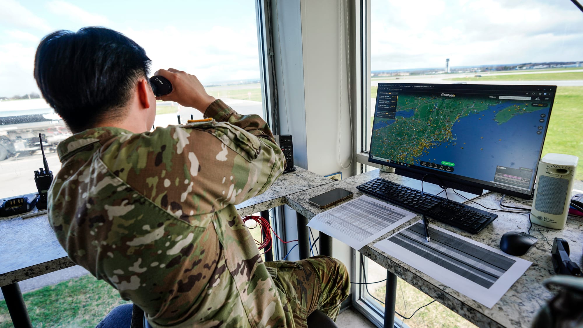 A member of the ground crew from Fort Drum looks for incoming Blackhawk helicopters Saturday. UH-60 Blackhawk helicopters fro