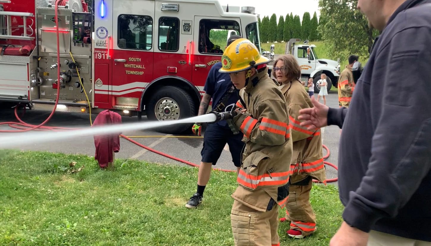 Camp attendee Jackson Deily participates in the firefighting demonstration.