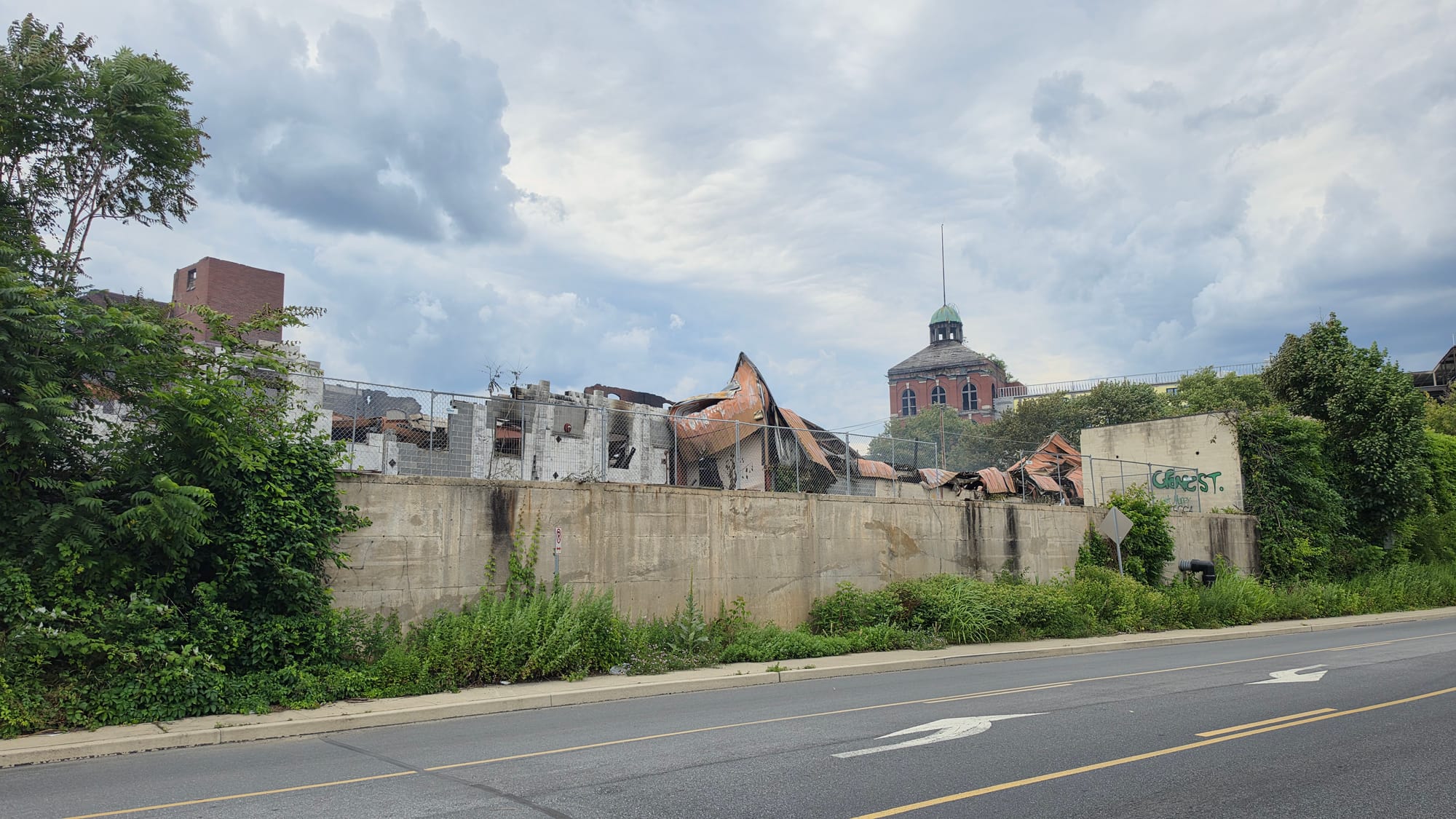 The burned-out remains of the former American Atelier furniture factory on Front Street continued to smolder Thursday, June 2