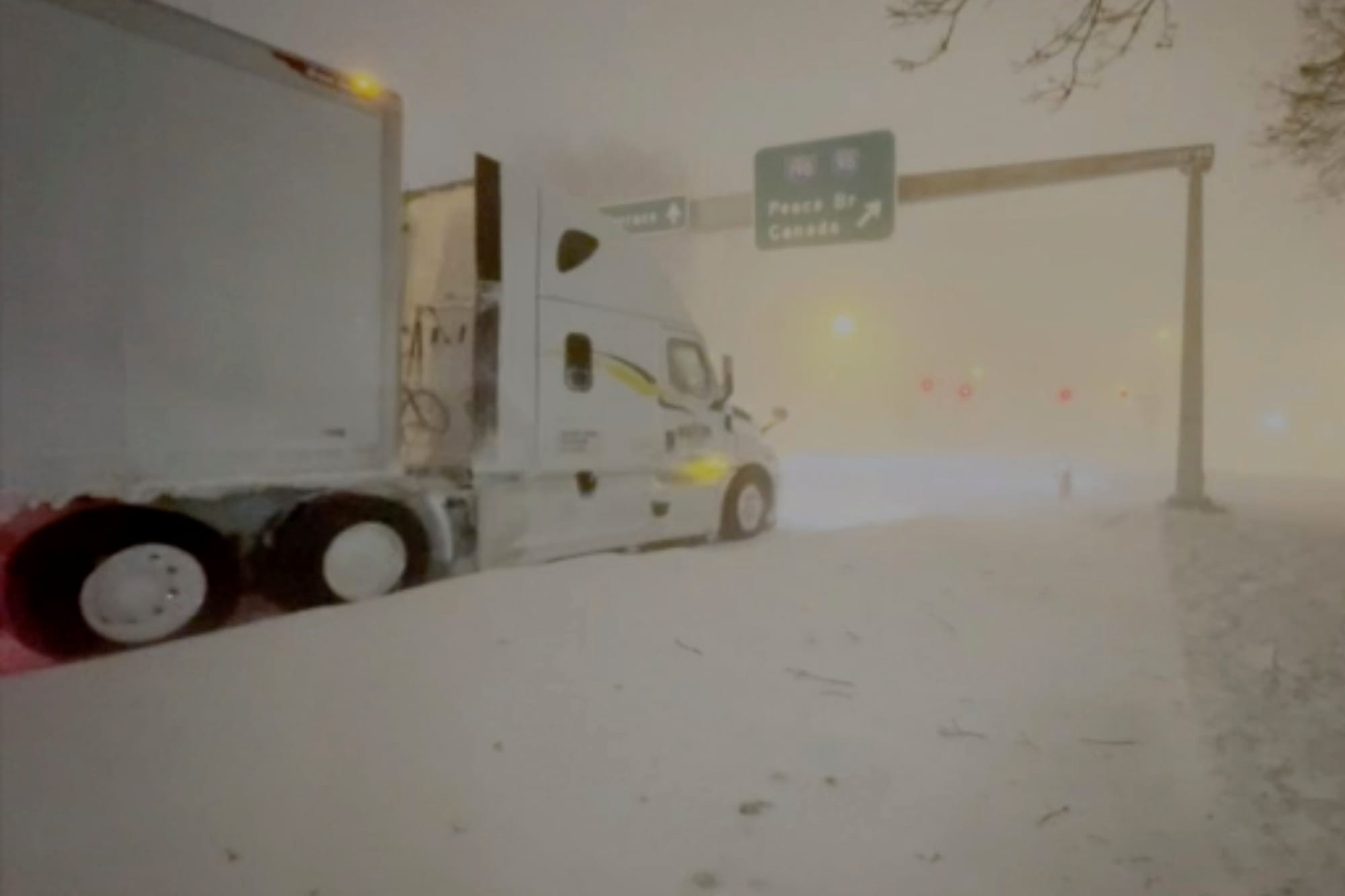High winds and snow covers the streets and vehicles in Buffalo, N.Y. early Sunday, Dec. 25, 2022. Millions of people hunkered