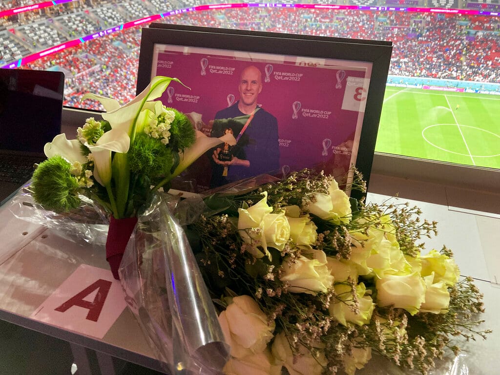 A tribute to journalist Grant Wahl is seen on his previously assigned seat at the World Cup quarterfinal soccer match between