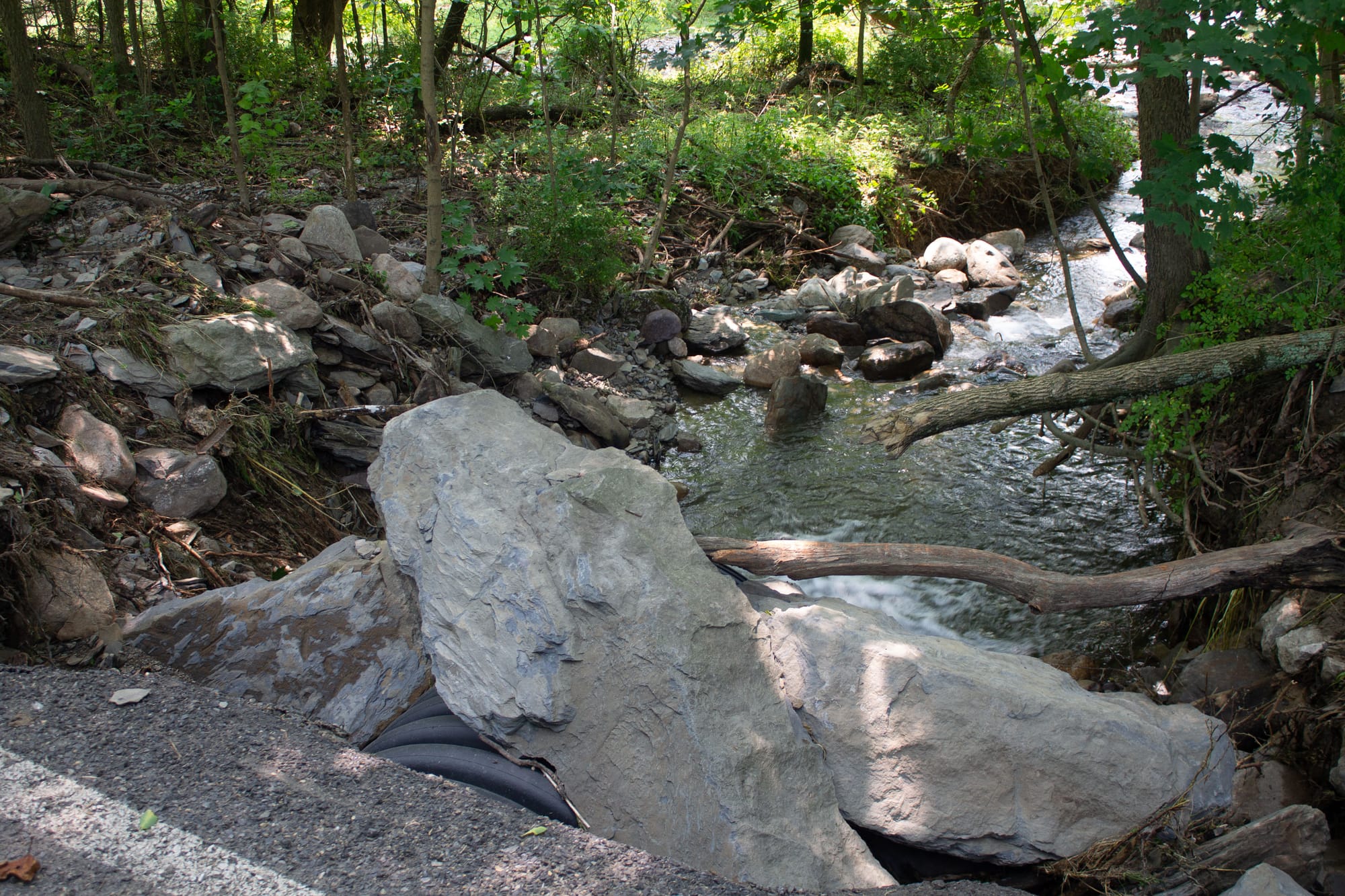 Giant rocks moved by the water, luckily leaving the drain pipe unblocked.