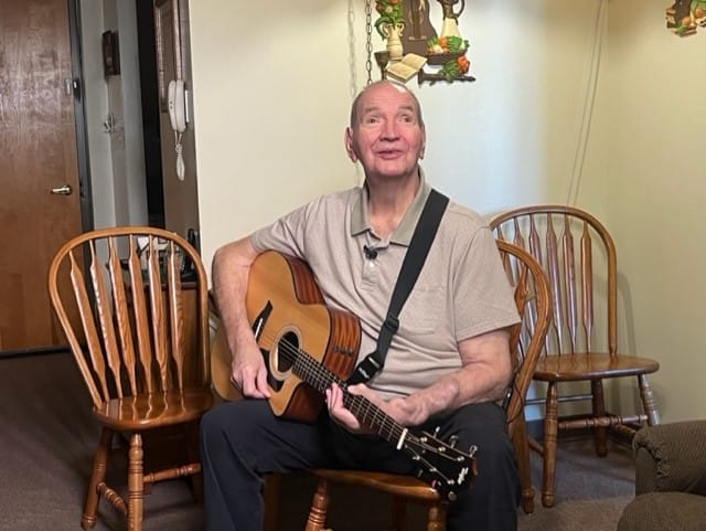 Duane Hawk plays the guitar.