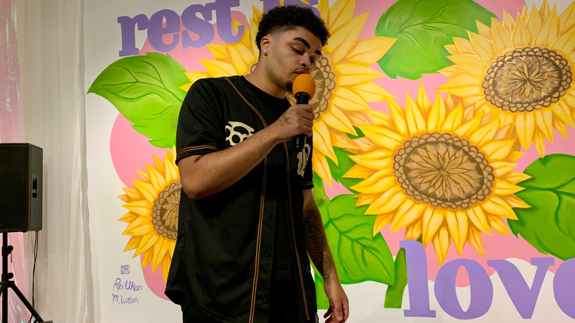 Allentown-based artist Syncere Jackson sings during the 'Restoring Petals' reception.