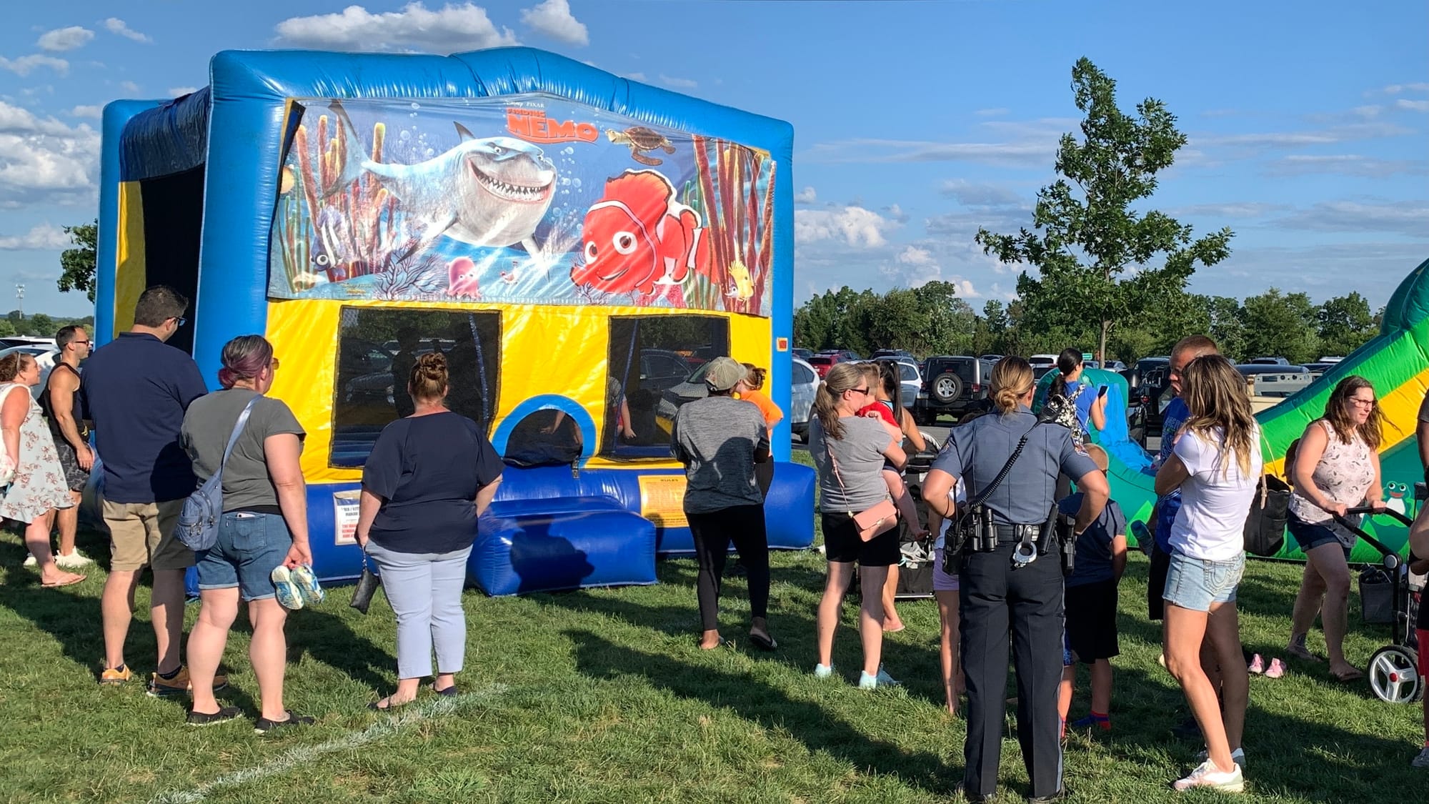 People wait in line for one of the bouncy houses at Upper Macungie's National Night Out event.