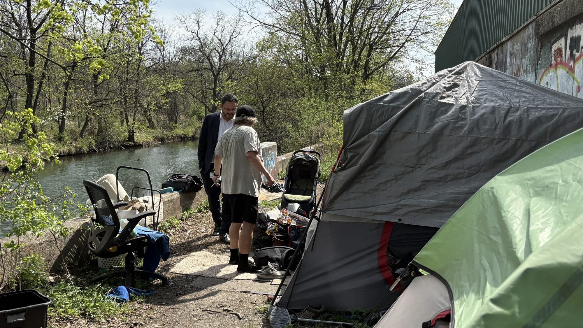 Allentown Managing Director Frank Kane speaks Wednesday, April 15, with a man who lives in a homeless camp along the Little L