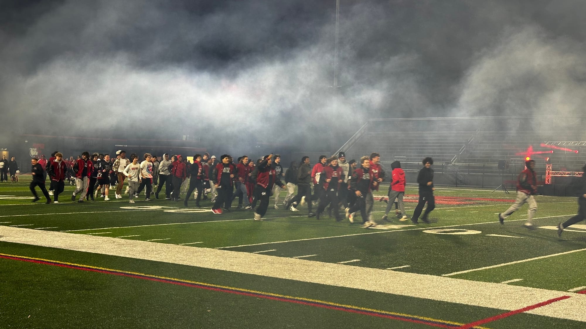 The football team takes to the Cottingham Stadium field.