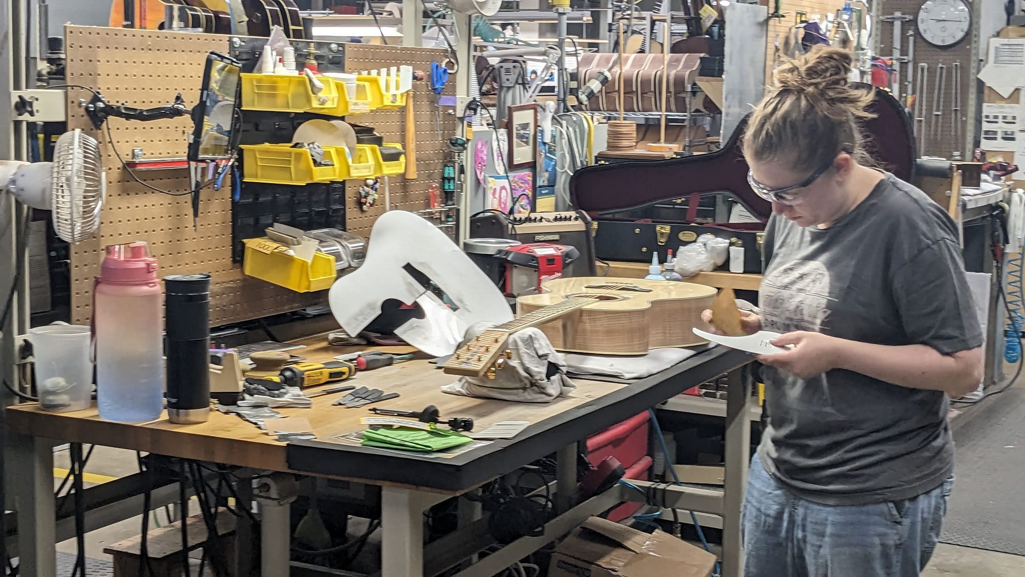 An employee at Martin in Upper Nazareth Township shapes a pickguard for a custom-ordered acoustic guitar.