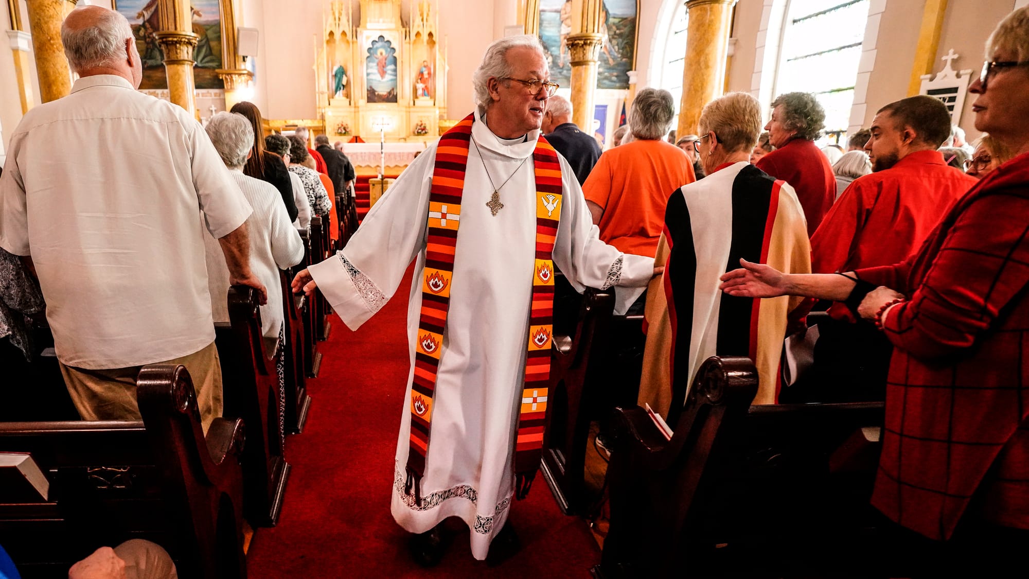 Rev. Mike Button, Interim Pastor, wishes peace on congregants. A Thanksgiving and Leave-Taking service was held at St. John's