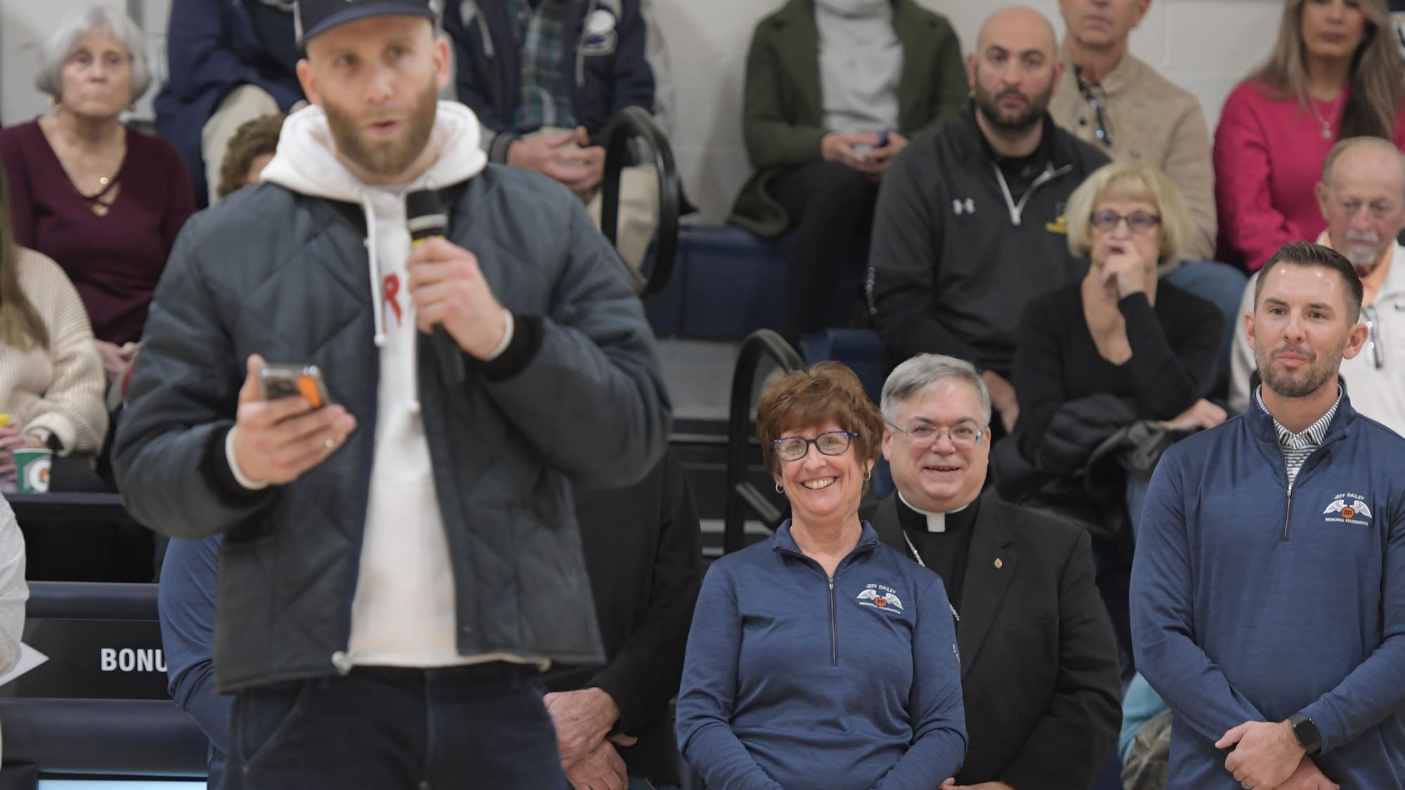Jane Dailey smiles as friend and former teammate Chadd Lilly talks about her son during a court dedication for Jeff Dailey on