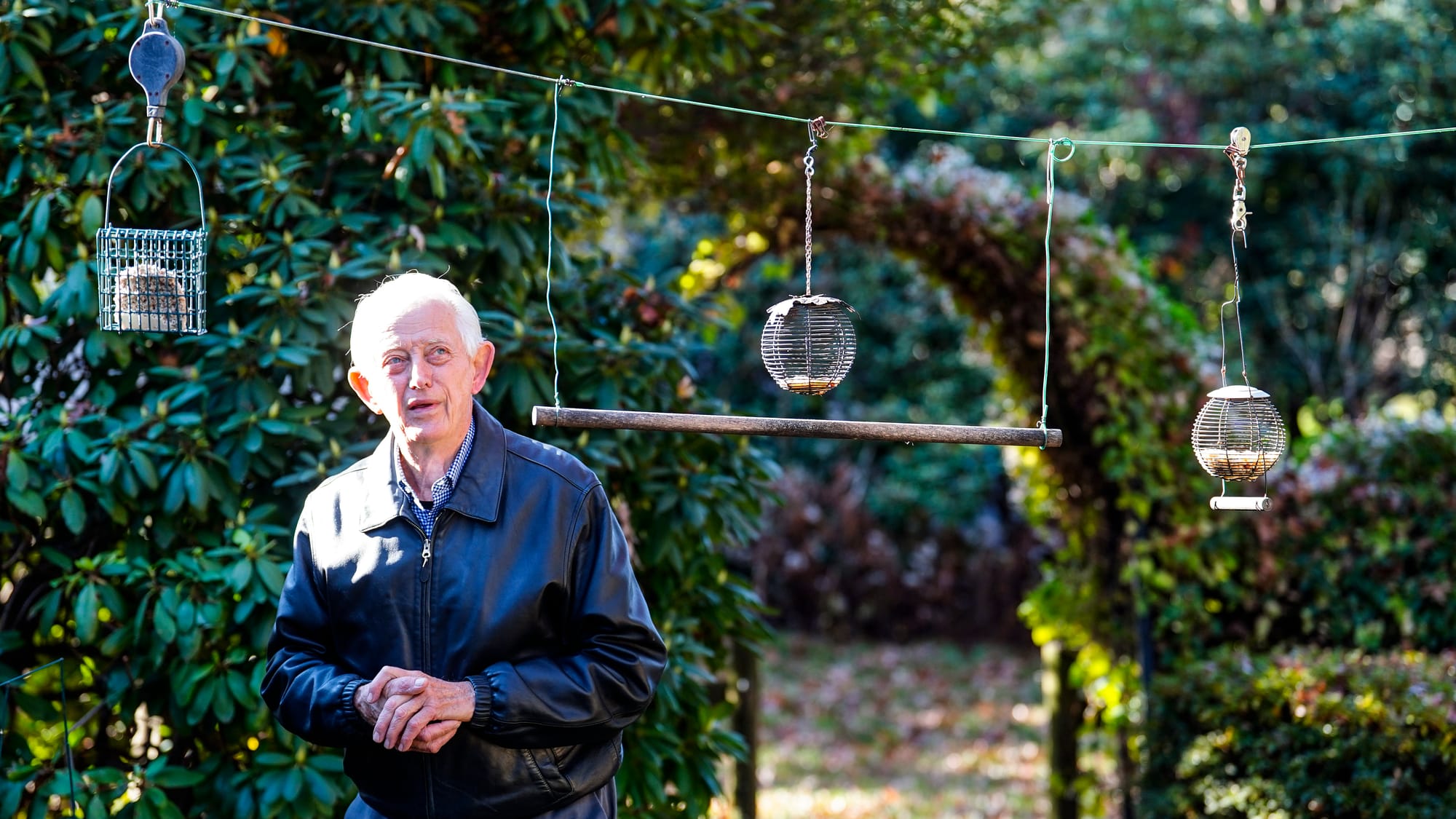Fred Buse checks his bird feeders in his backyard. Fred Buse, 87, of South Whitehall Township, has been tracking climate chan
