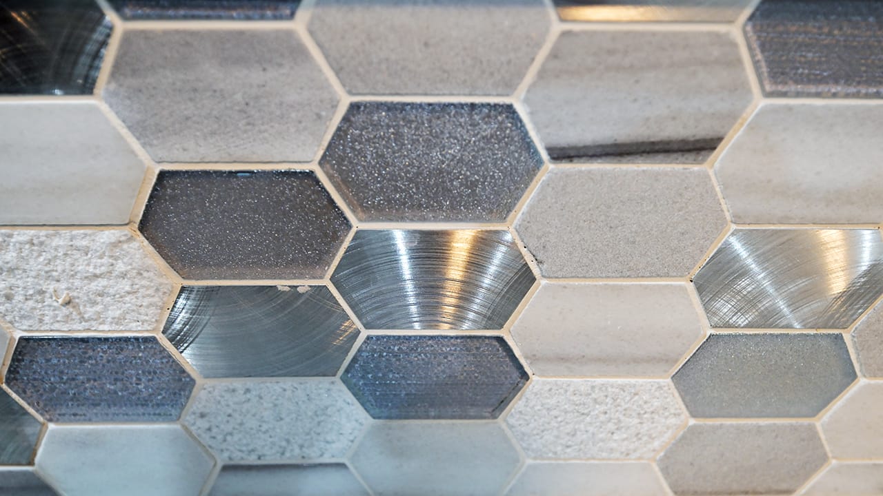 A kitchen backsplash with different textures is shown in the West Bethlehem home renovated by Wandra Cain.