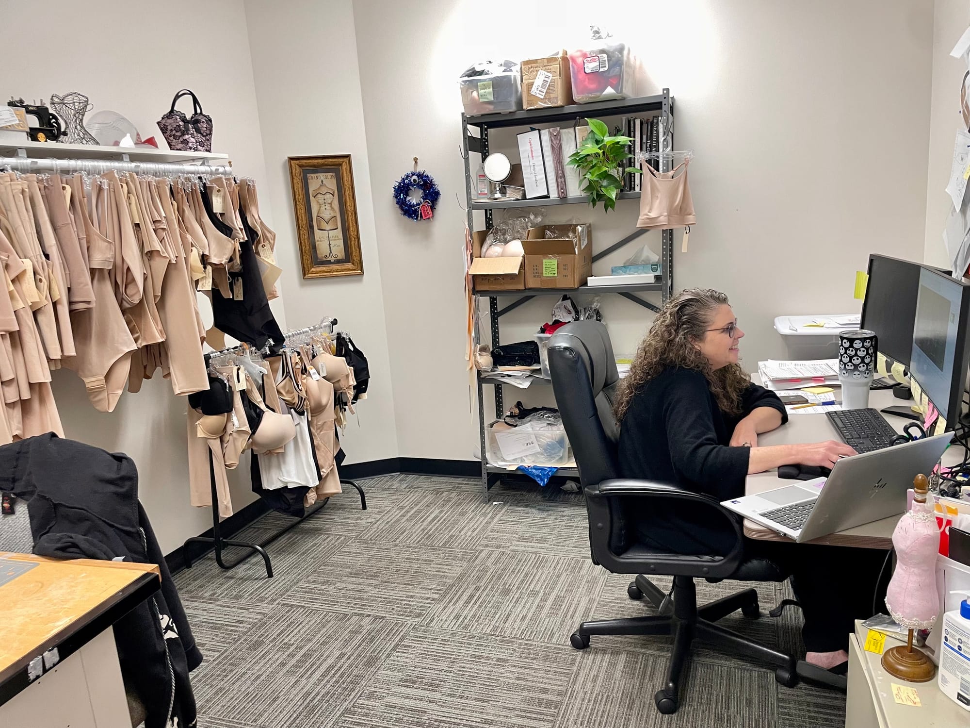 Cupid Intimates' senior shapewear designer Marialena Delfino surrounded by samples of the many original styles of shapewear t