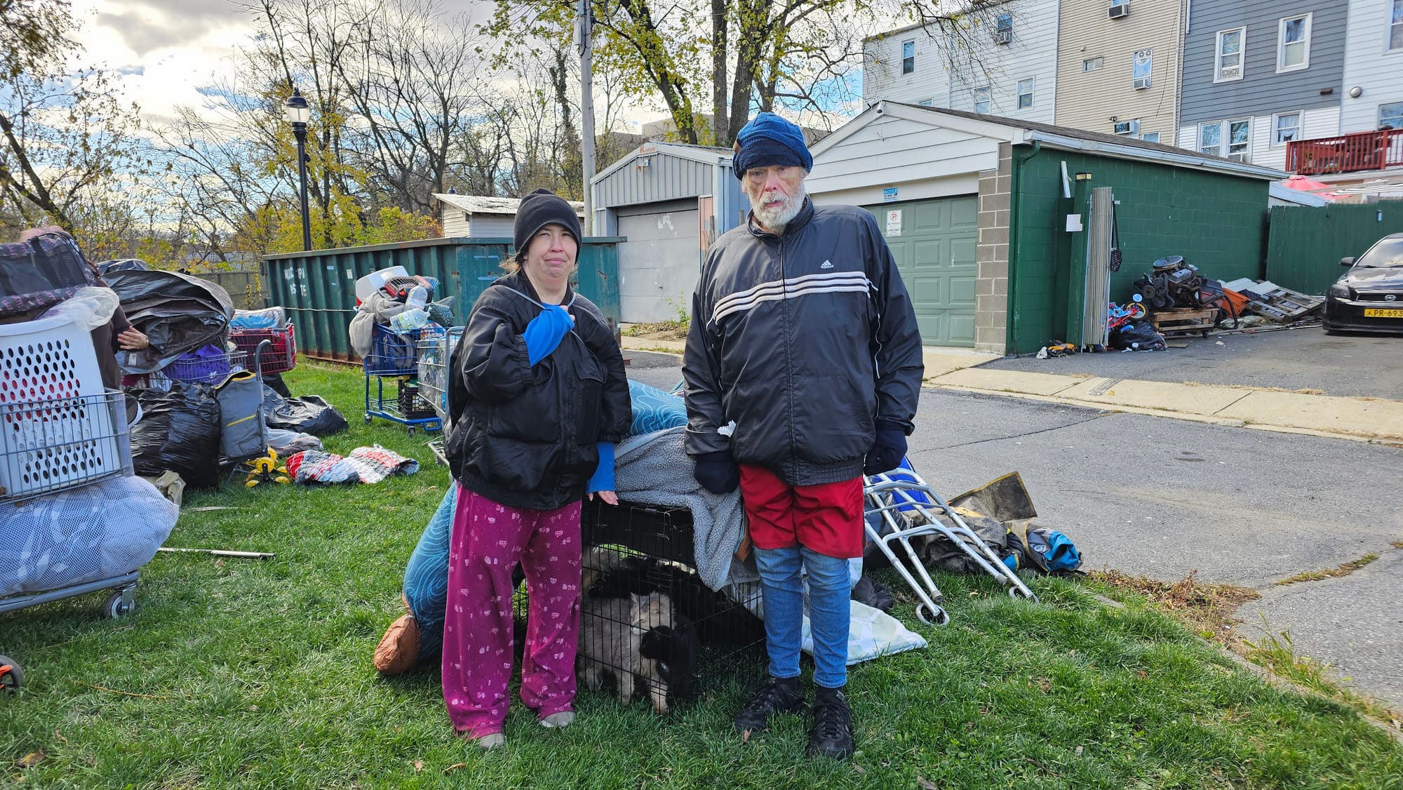 Joan Harwood (left) and Herbert Stewart pose for a photo with their two cats as crews work to clear the Jordan Creek Greenway