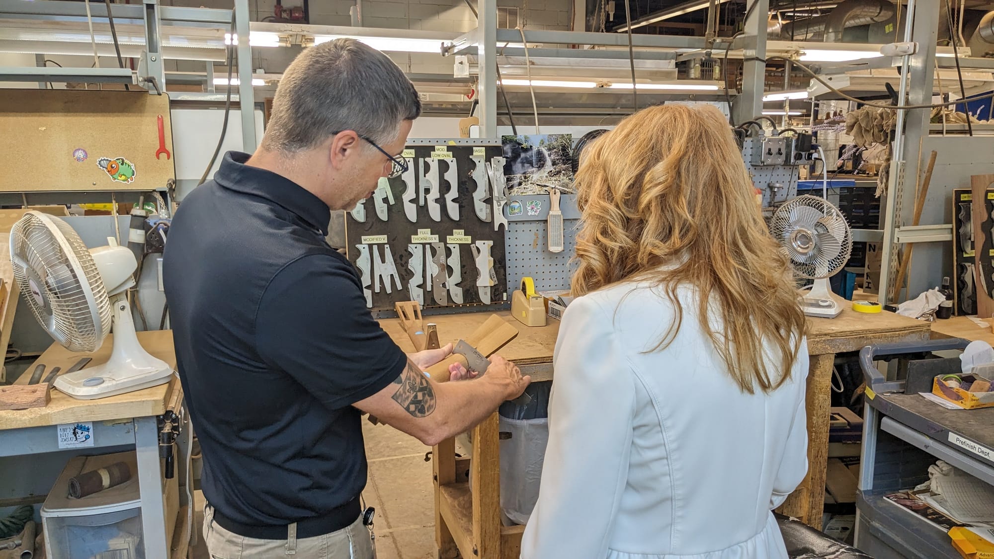 C.F. Martin and Co. archives and museum administrator Jason Ahner, left, shows Pa. Treasurer Stacy Garrity, right, how employ