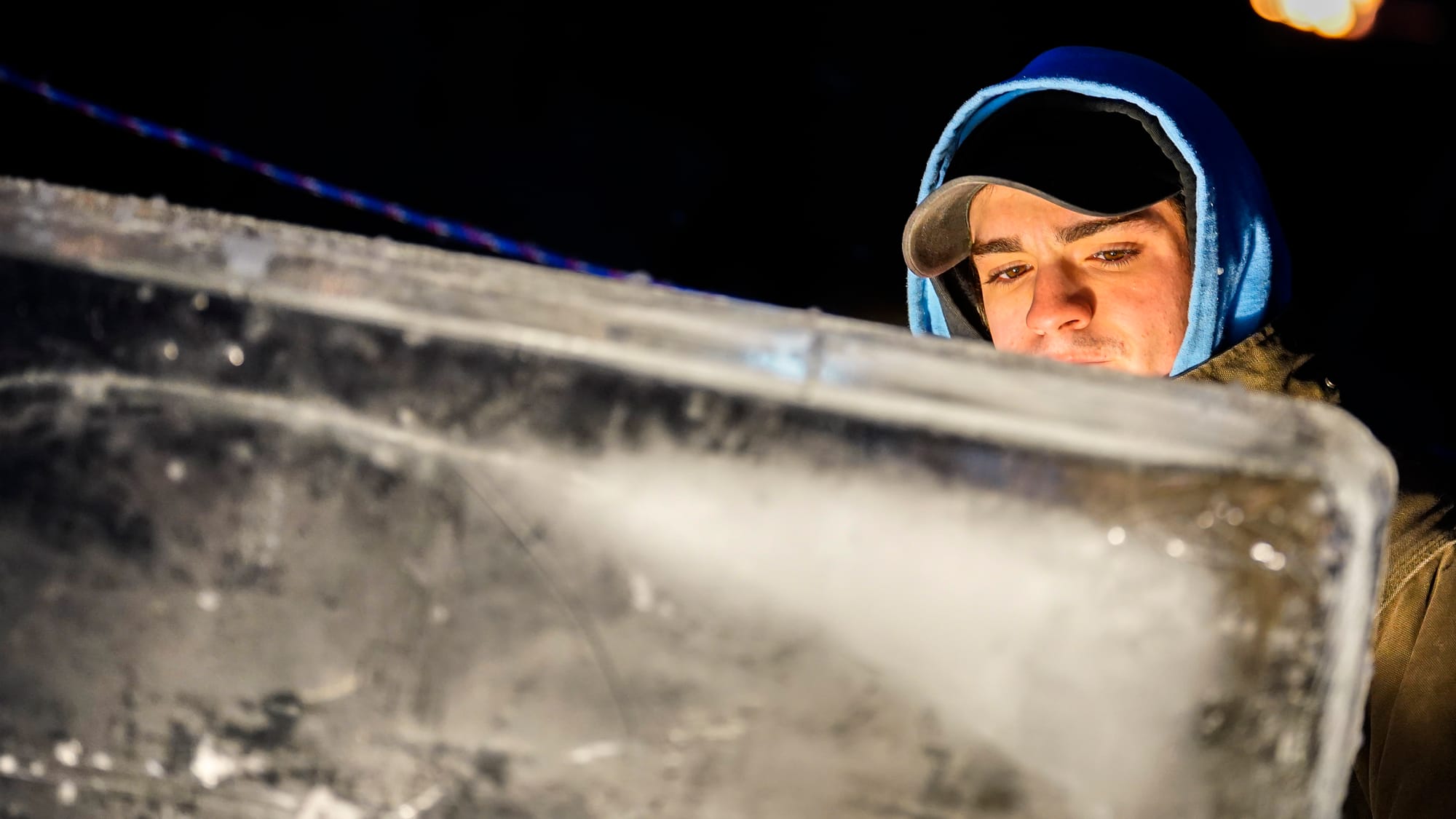 Ice sculptor Elijah Hogan of Milford, Pa., carves the Illumination logo. The Lehigh Valley IronPigs are hosting Illumination,