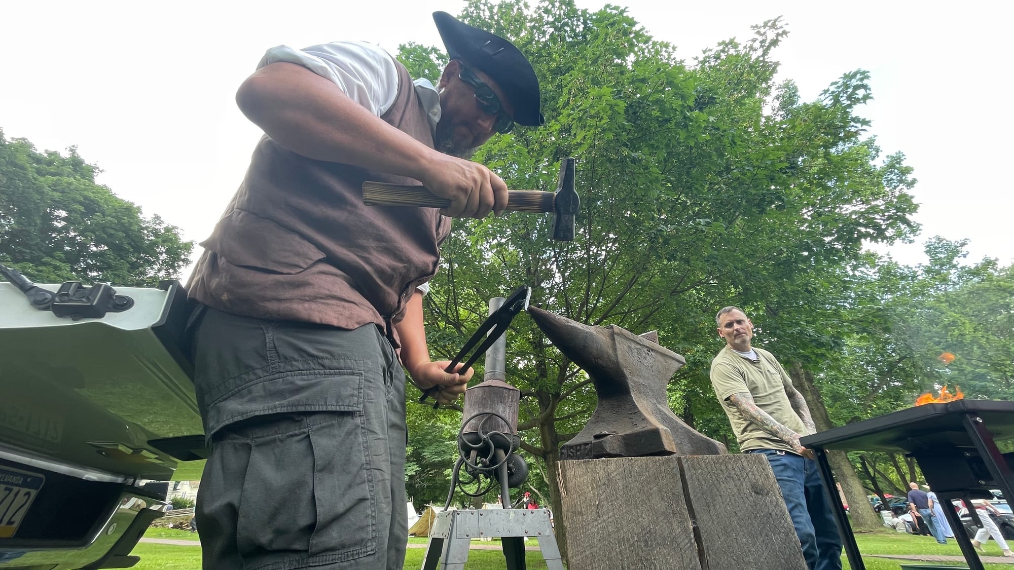 David Marchese works at hammering a hot piece of iron.