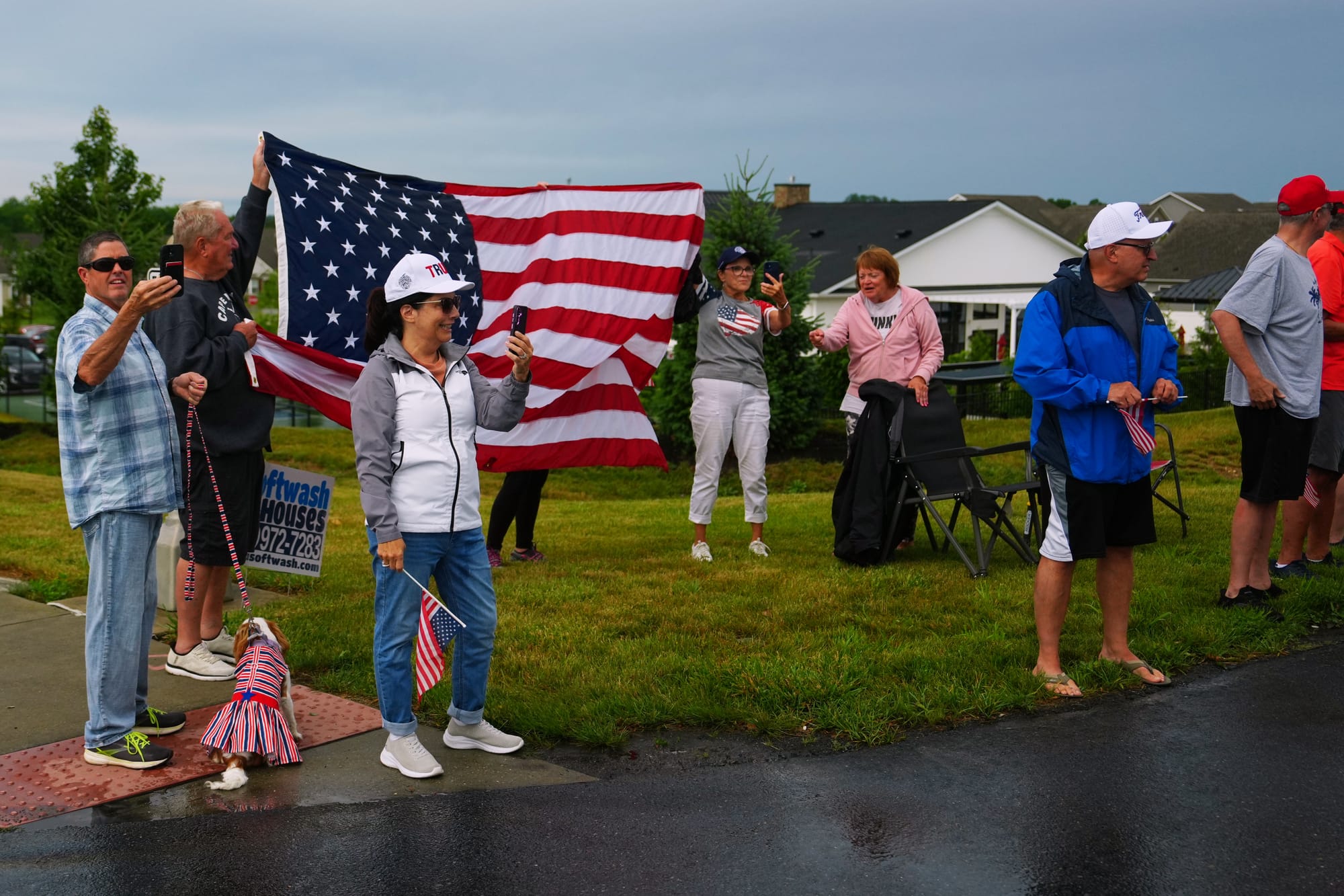 People wave at President Donald Trump's motorcade as it passes by Tuesday, June 23, 2026, in Macungie, Pa.