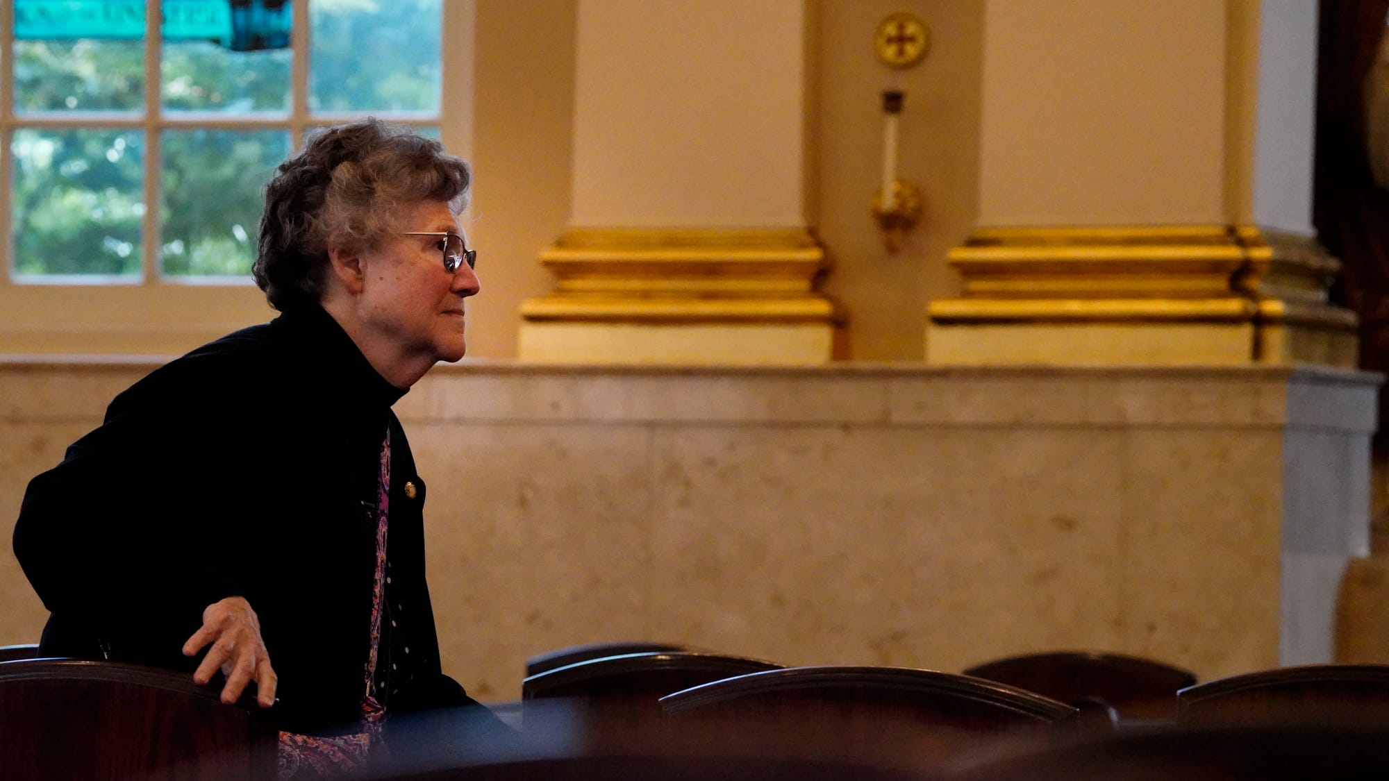 A mourner makes her way to the late Bishop Cullen. Ceremonies of Reception of the Body and Visitation for The Most Reverend E