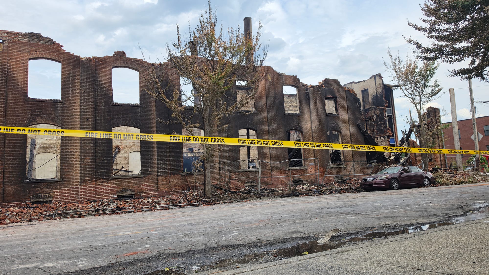 The blaze destroyed the former American Atelier furniture factory while also damaging rowhomes across Front Street and severa