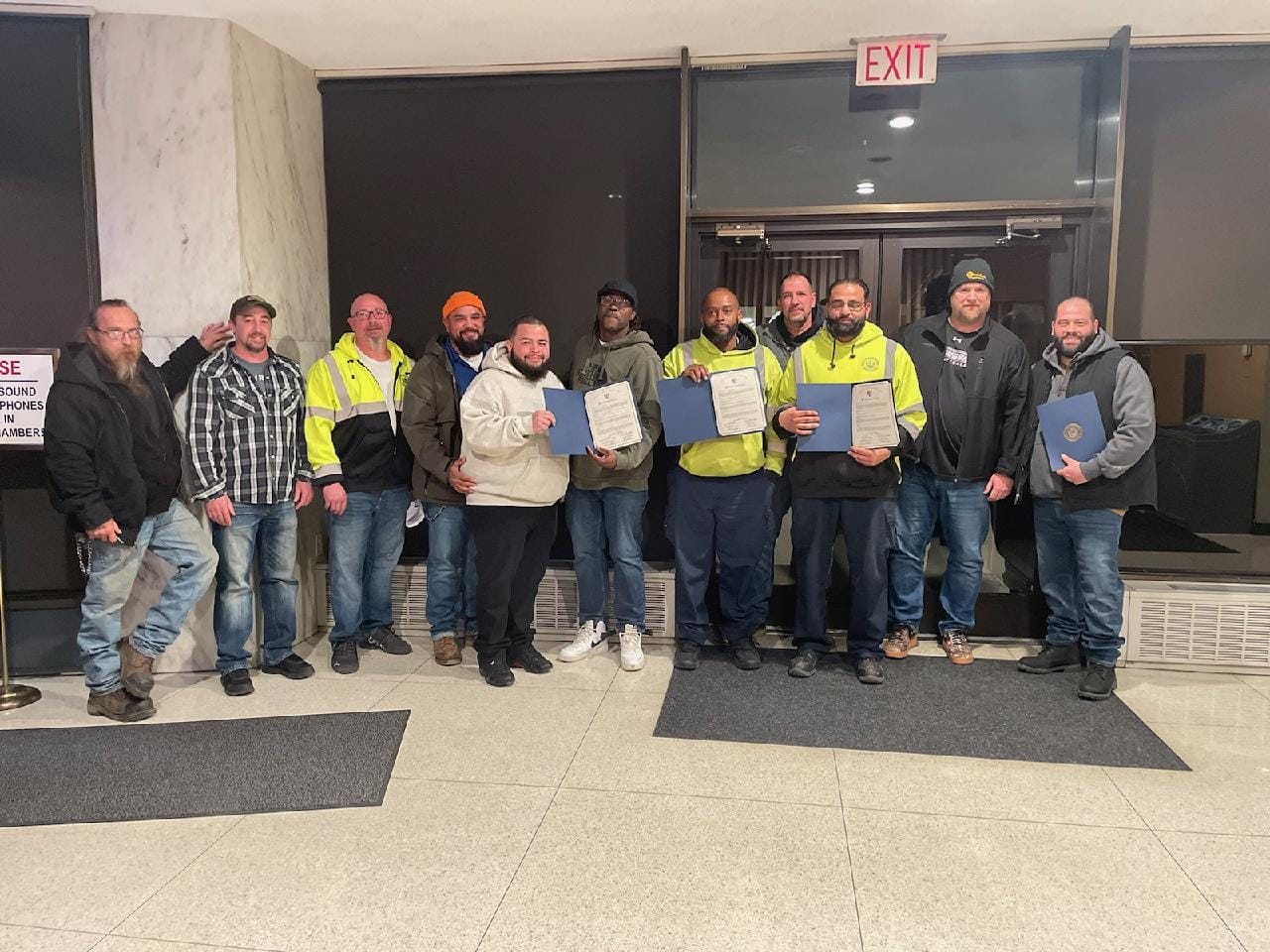 Members of the Streets Department of Allentown Public Works posing with their copies of the proclamation. The group was on sc