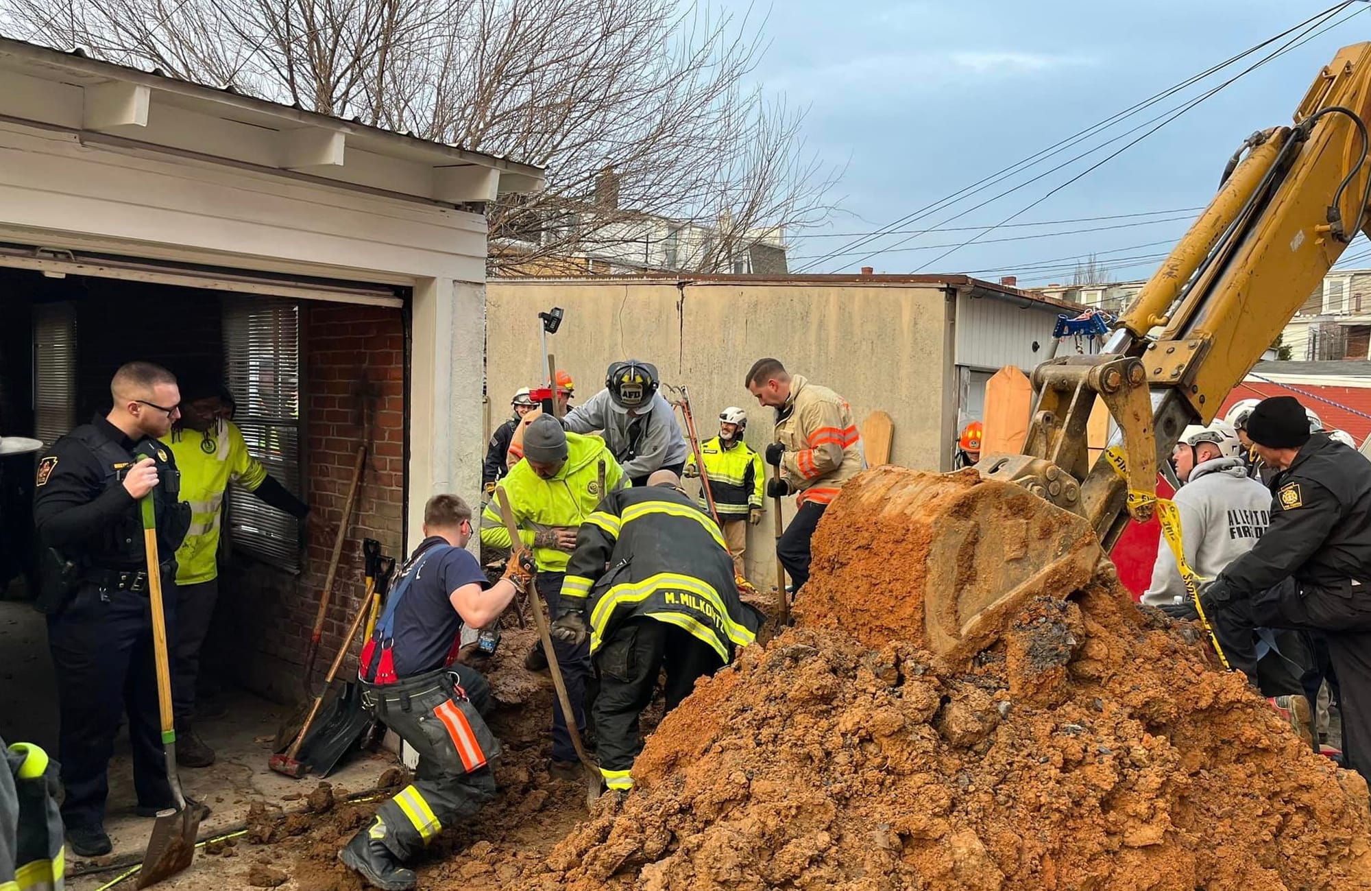 Rescuers work to free a man Wednesday trapped underground during a construction accident near 15th and Gordon streets.