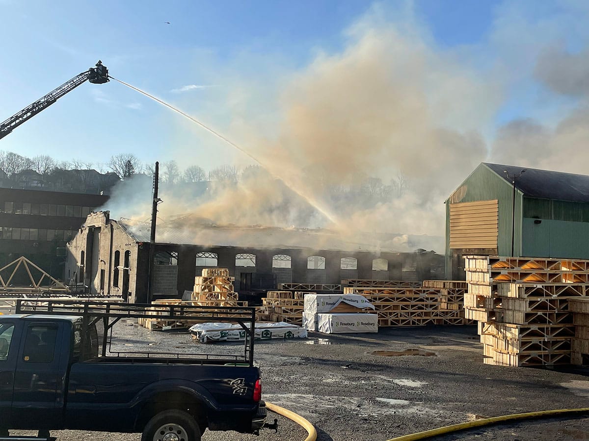 Firefighters spray a building early Tuesday on Lehigh Drive after a massive fire broke out in the area.