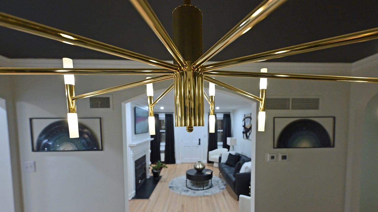 A chandelier above the dining room table in a West Bethlehem home designed by Wandra Cain.