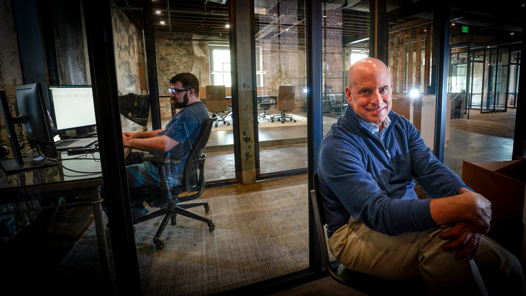 Gregg Marzano, associate advisor of SVN Imperial Realty, right, sits in a workspace on the second floor of 225 Ferry Street. 
